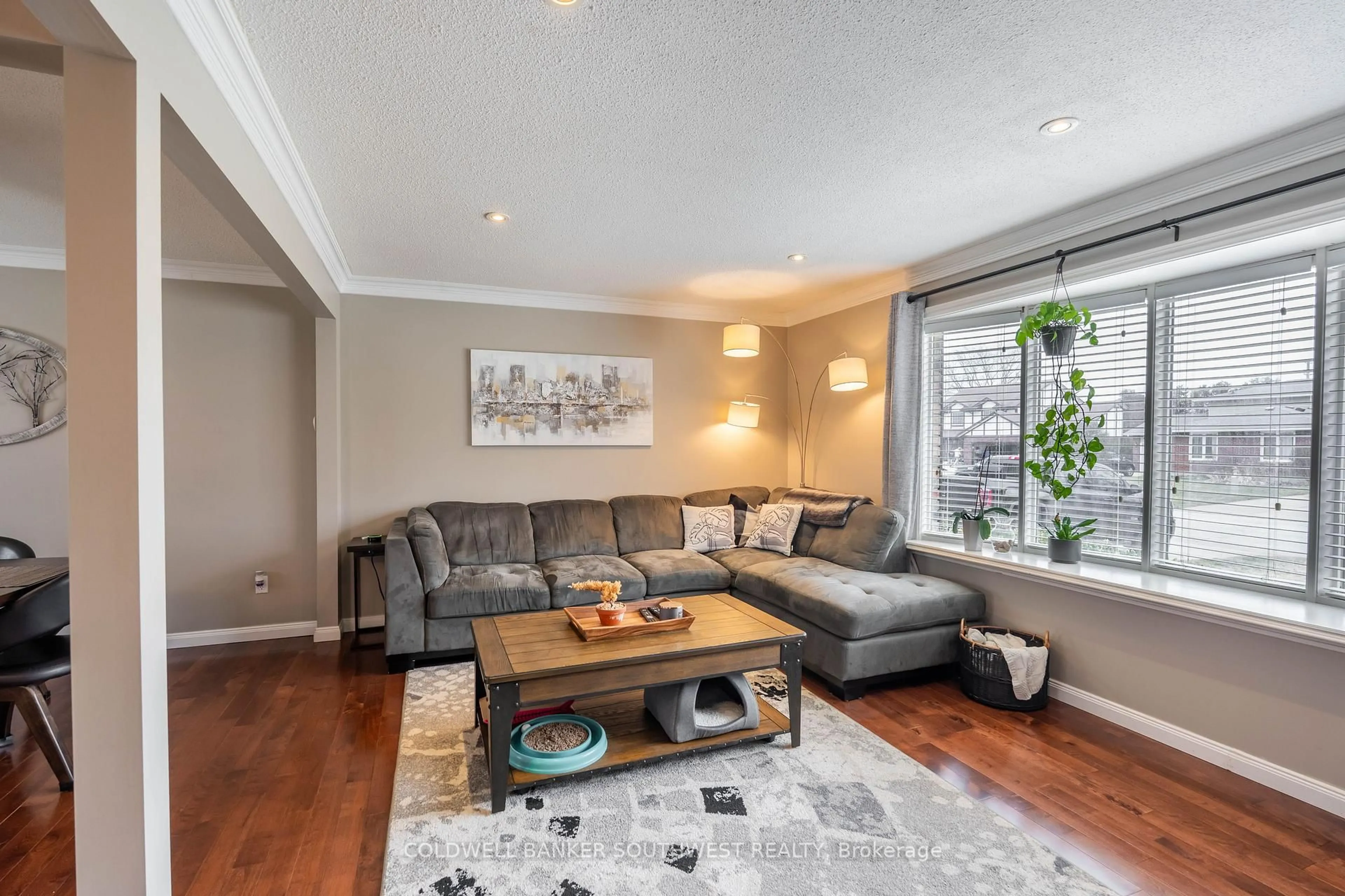 Living room with furniture, wood/laminate floor for 668 Winchester Cres, Sarnia Ontario N7S 4P5