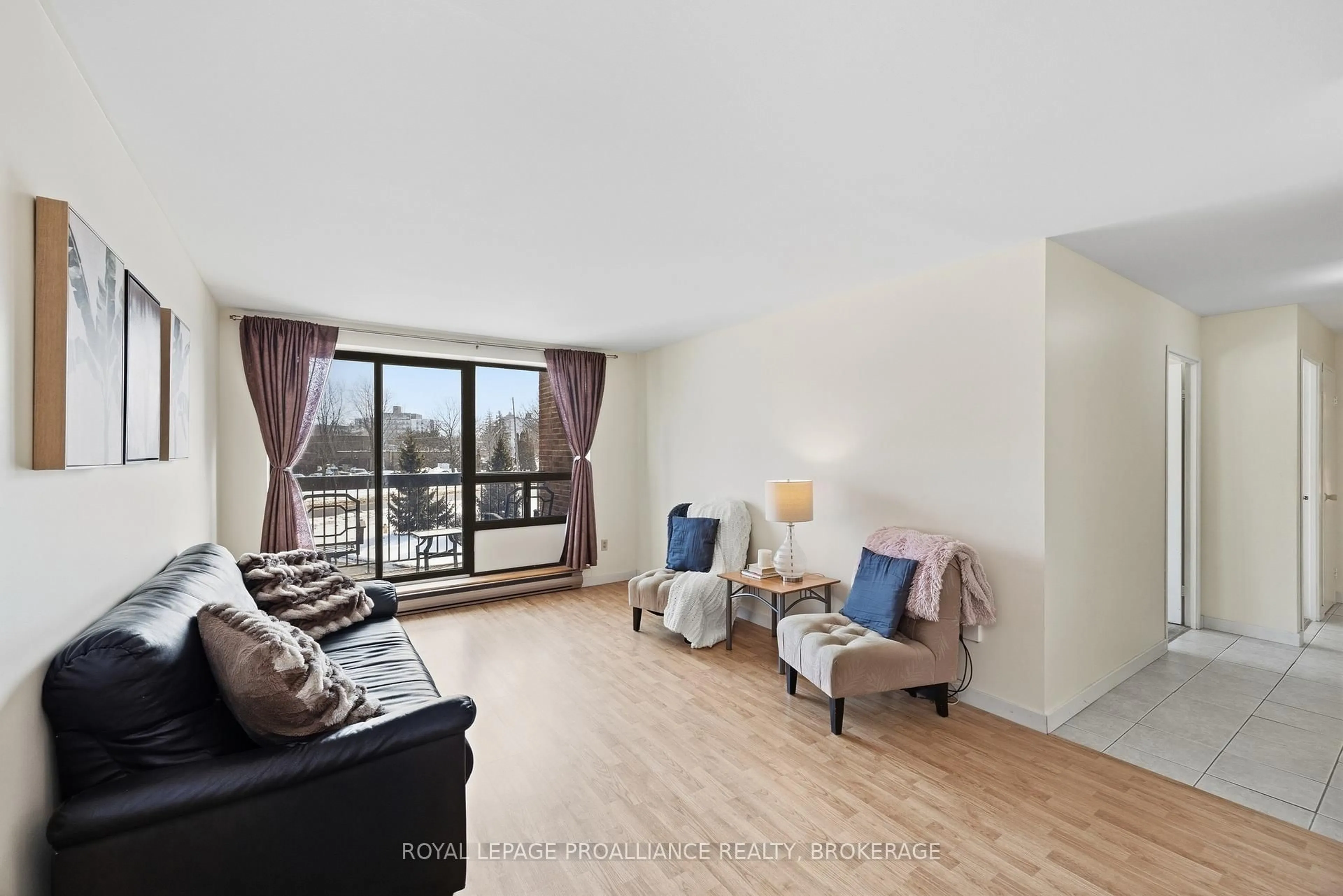 Living room with furniture, wood/laminate floor for 334 Queen Mary Rd #207, Kingston Ontario K7M 7E7