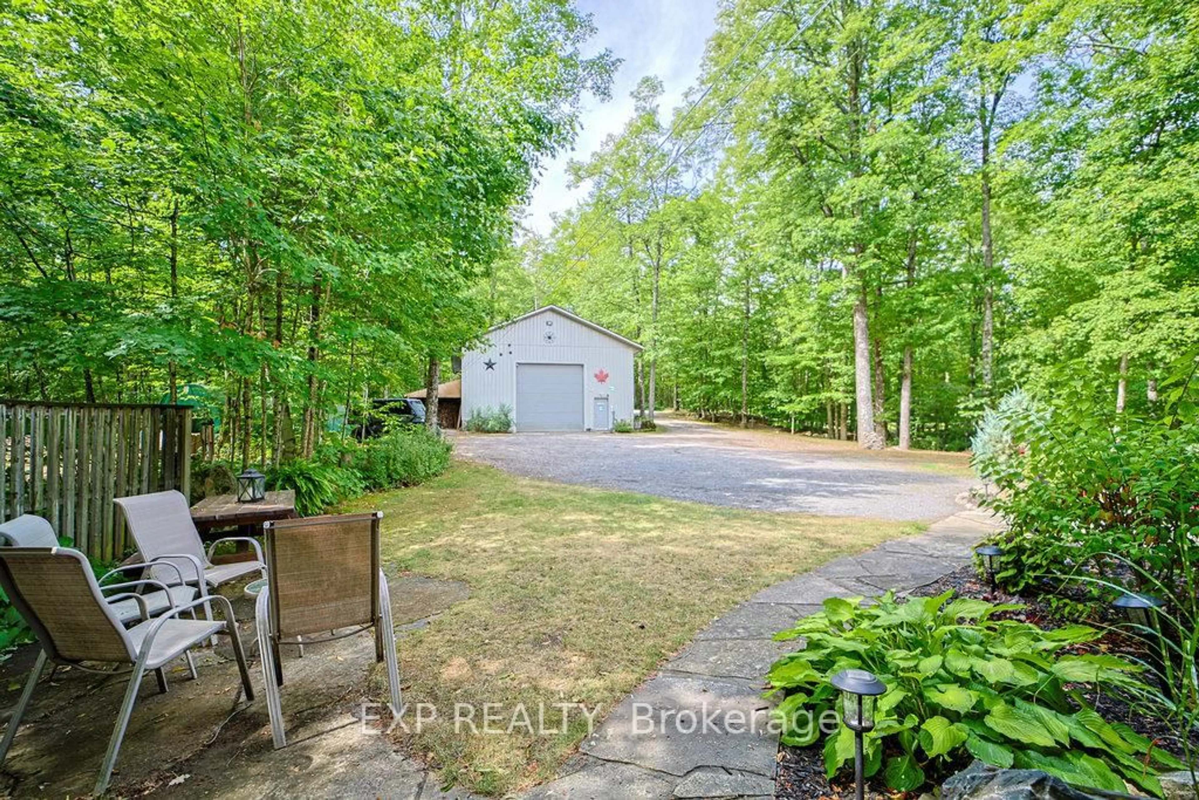 A pic from outside/outdoor area/front of a property/back of a property/a pic from drone, forest/trees view for 27 Sylvan Dr, North Kawartha Ontario K0L 1A0