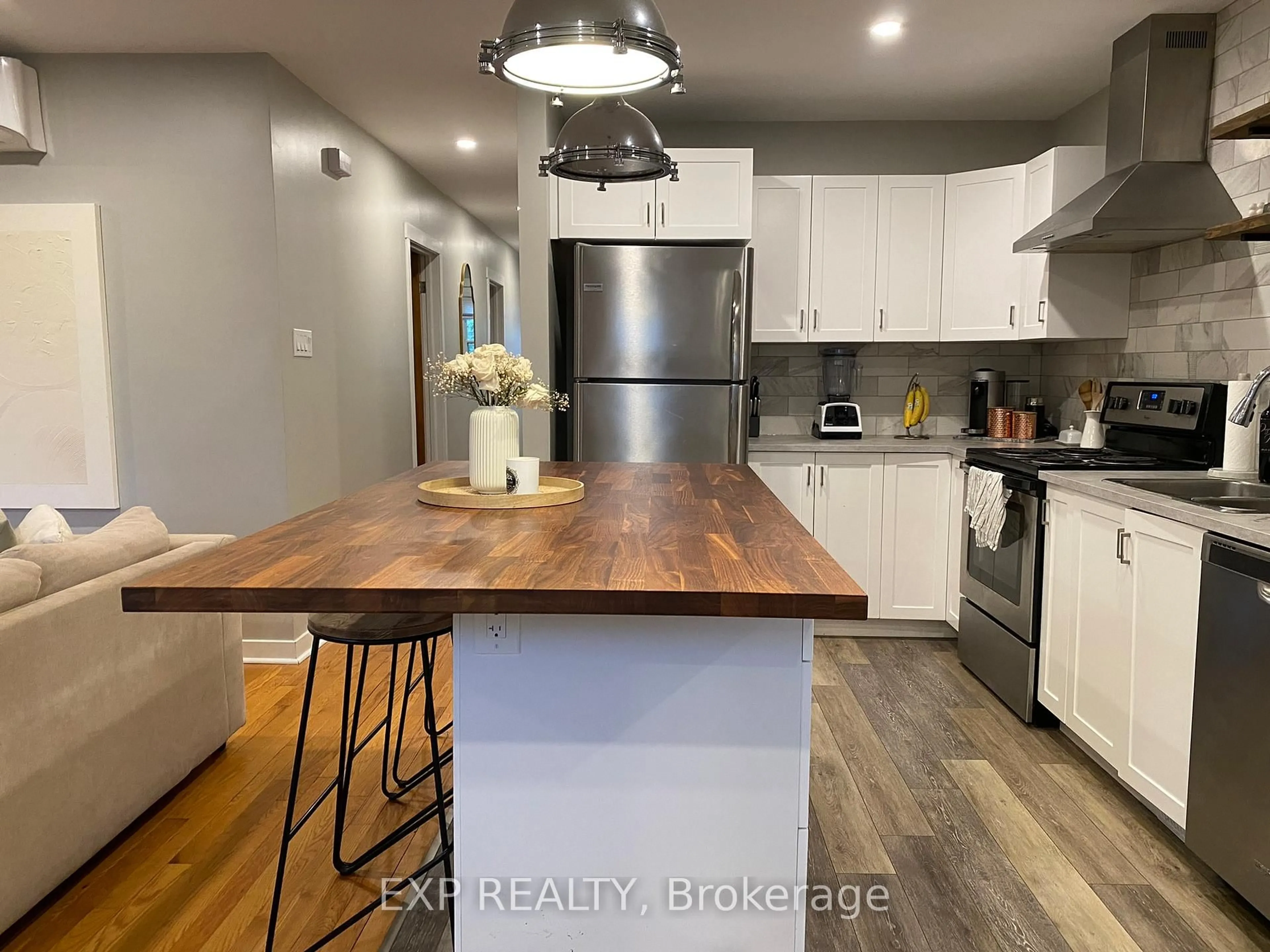 Open concept kitchen, wood/laminate floor for 1237 Vancouver Ave, Ottawa Ontario K1V 6V2