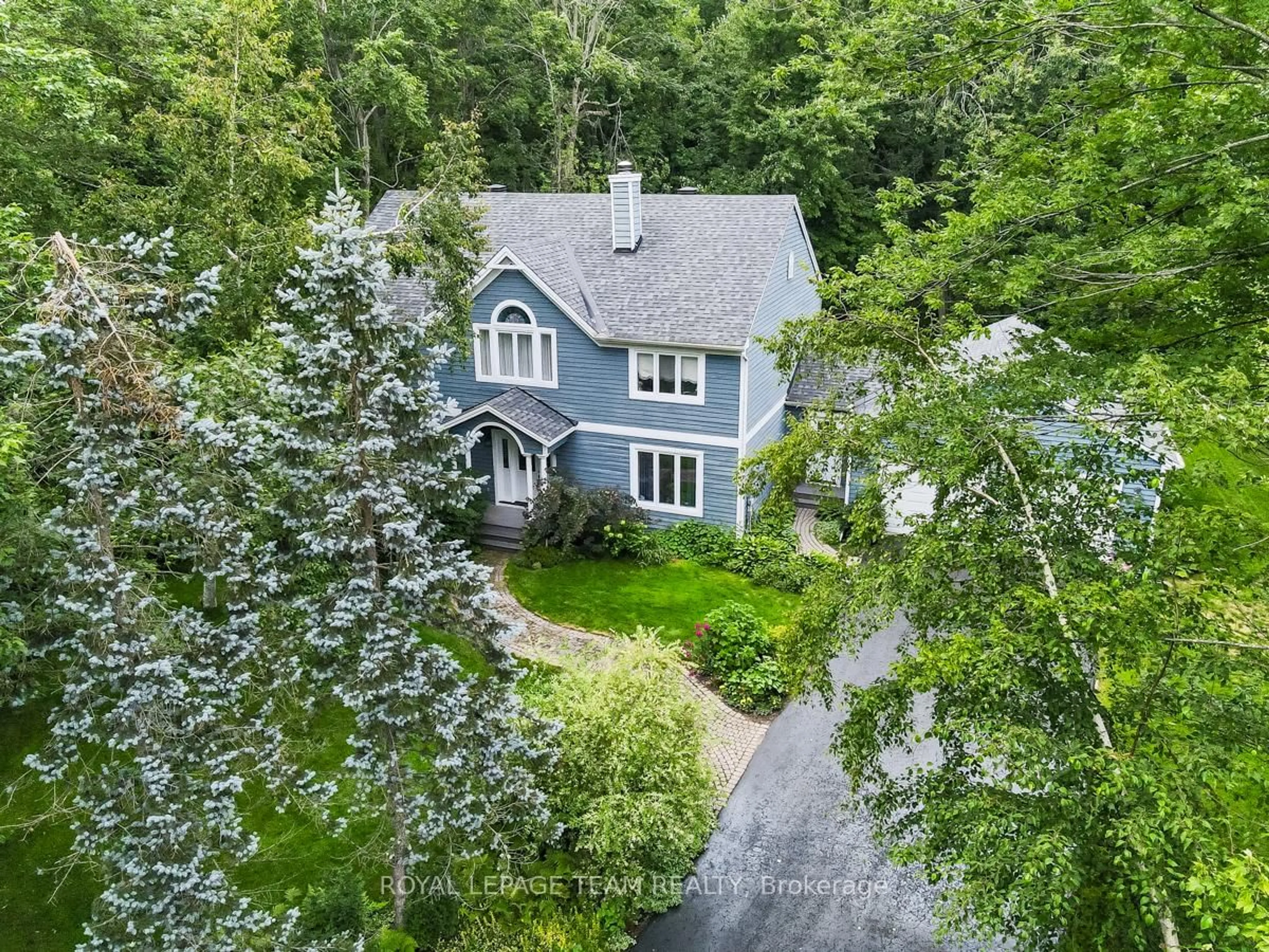 A pic from outside/outdoor area/front of a property/back of a property/a pic from drone, forest/trees view for 5517 Cedar Dr, Ottawa Ontario K4M 1B4