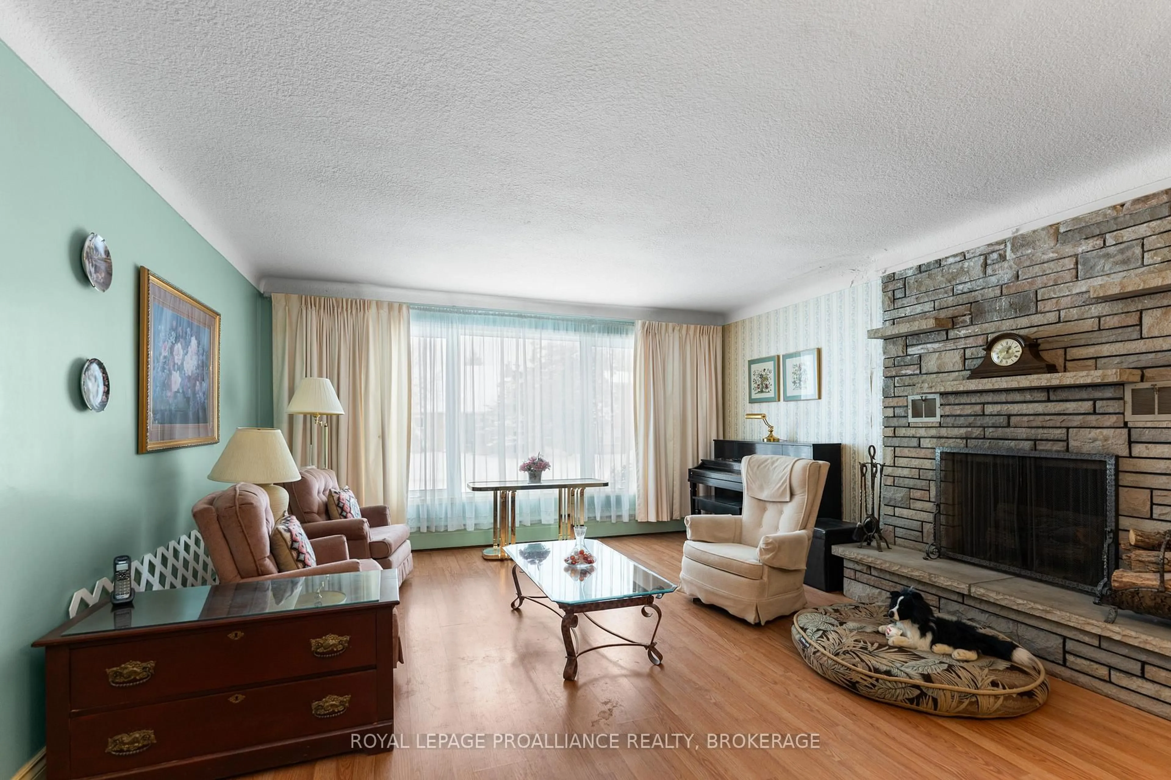 Living room with furniture, wood/laminate floor for 81 Robert Wallace Dr, Kingston Ontario K7M 1X9