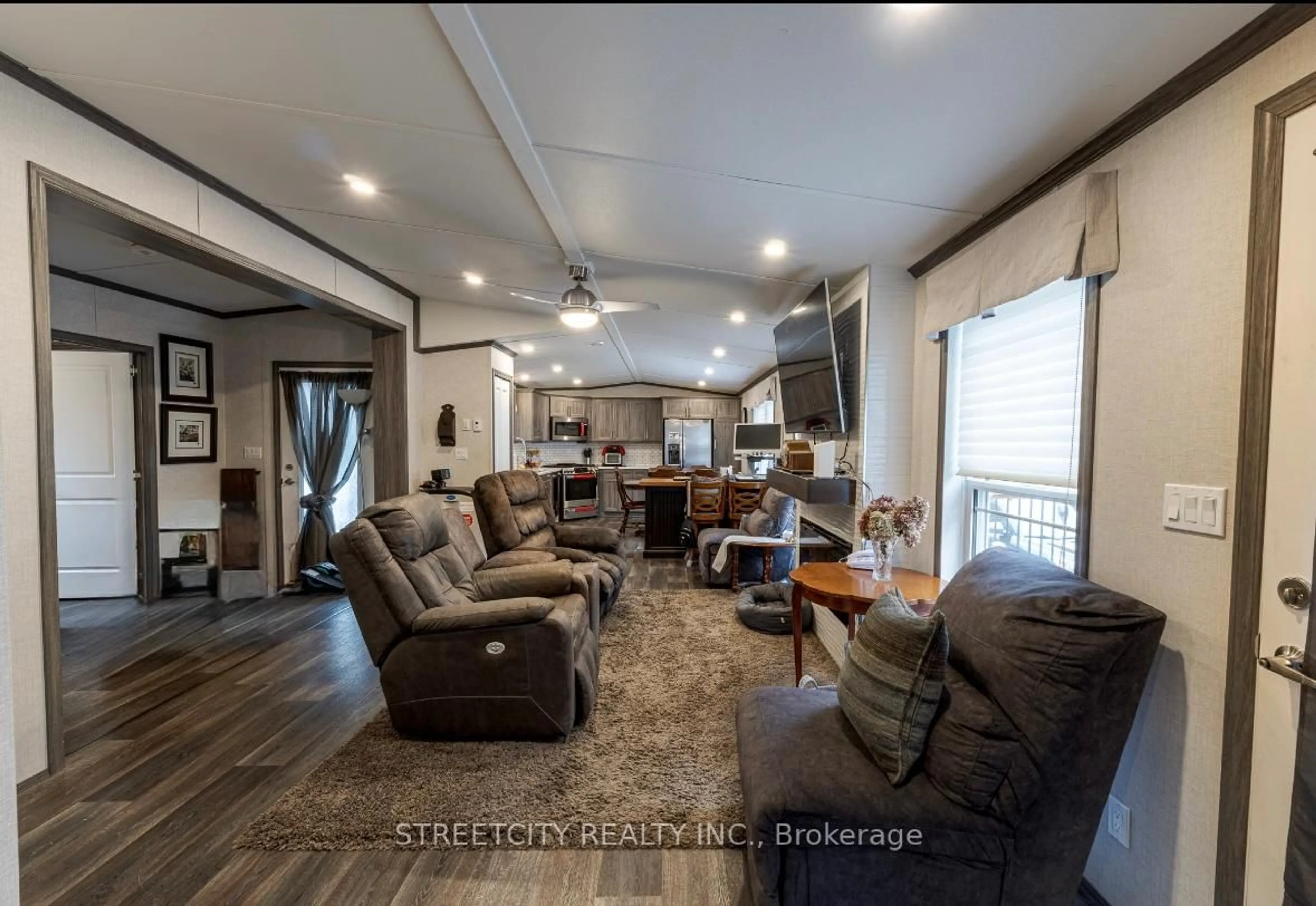 Living room with furniture, wood/laminate floor for 22790 Amiens Rd, Middlesex Centre Ontario N0L 1R0