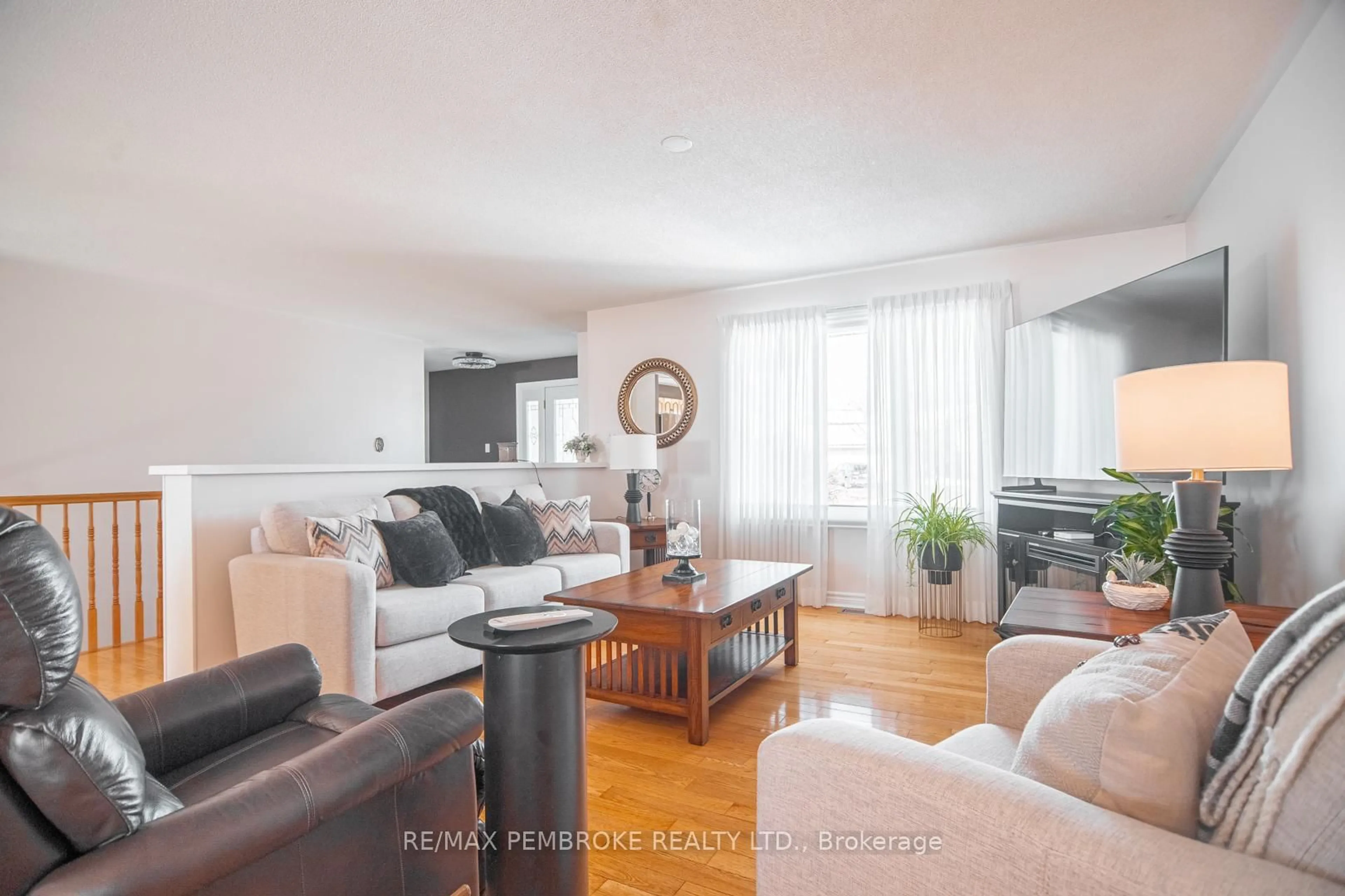 Living room with furniture, wood/laminate floor for 529 Angus Campbell Dr, Pembroke Ontario K8A 8K5