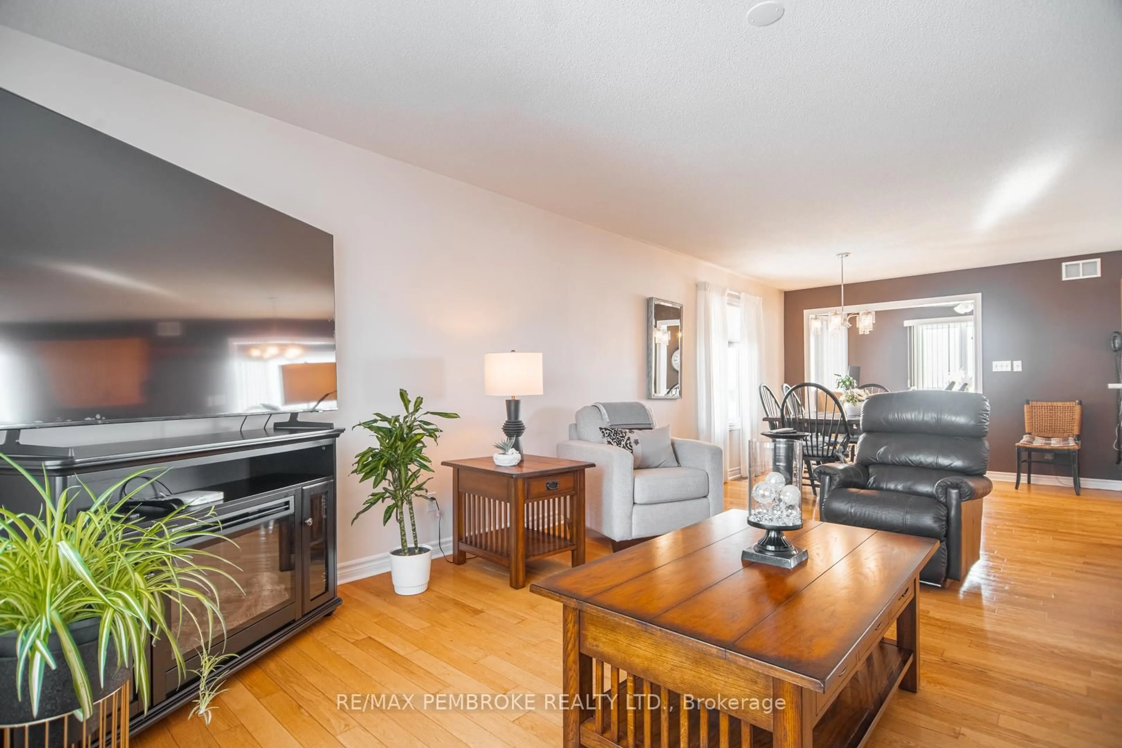 Living room with furniture, wood/laminate floor for 529 Angus Campbell Dr, Pembroke Ontario K8A 8K5