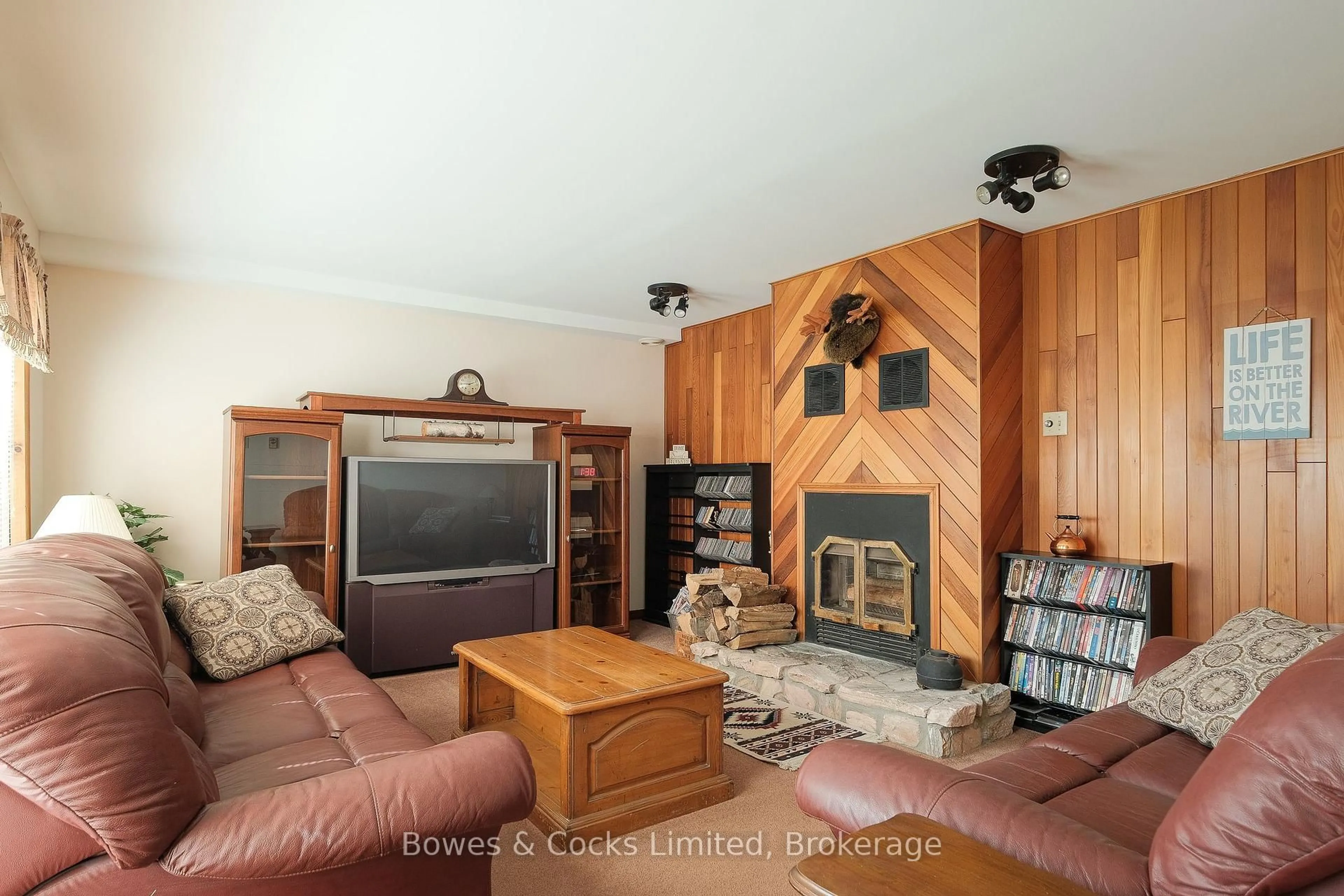 Living room with furniture, wood/laminate floor for 210 Thompson Rd, Otonabee-South Monaghan Ontario K9J 6X8