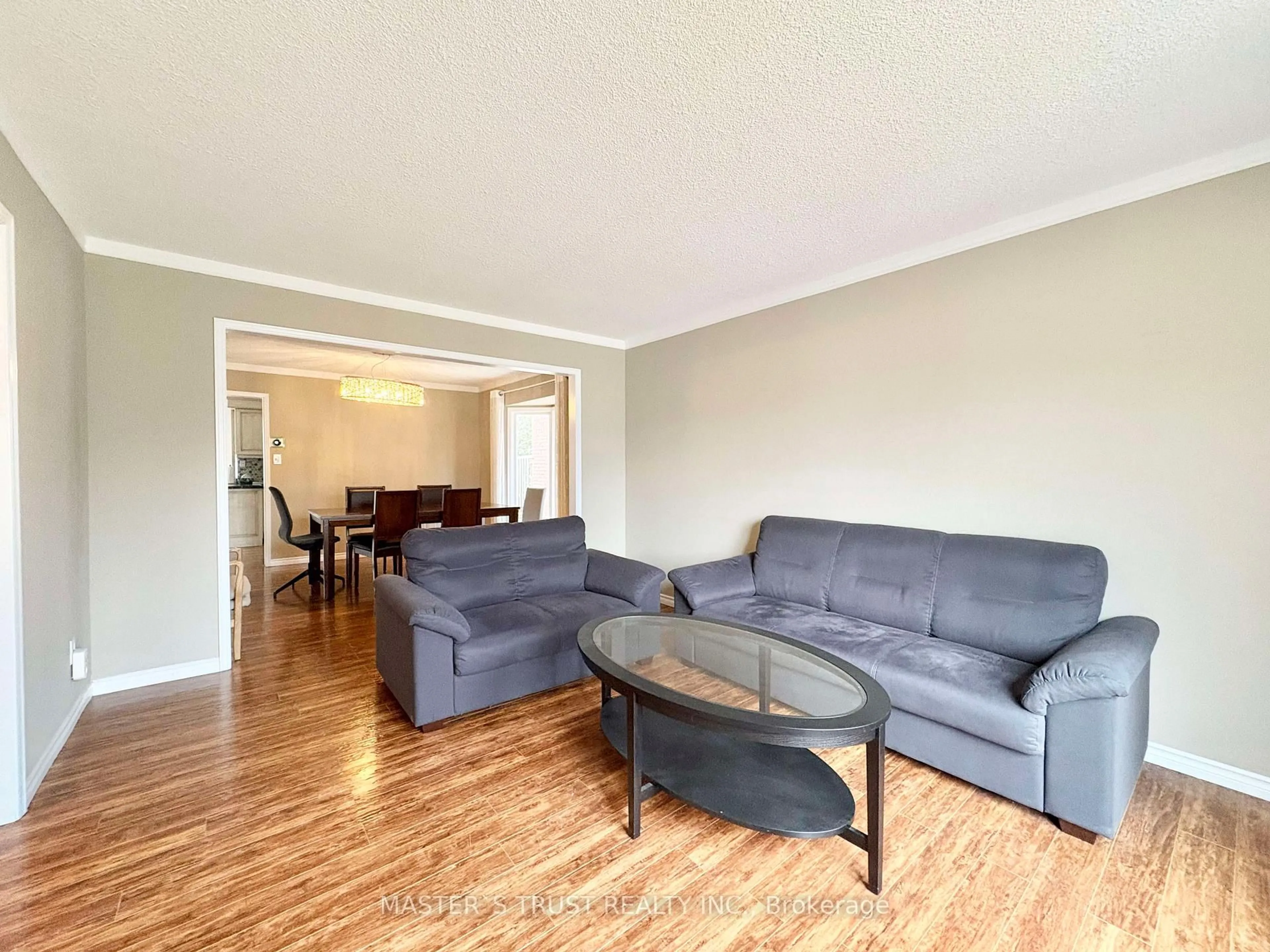 Living room with furniture, wood/laminate floor for 138 Huntingwood Ave, Hamilton Ontario L9H 6X7