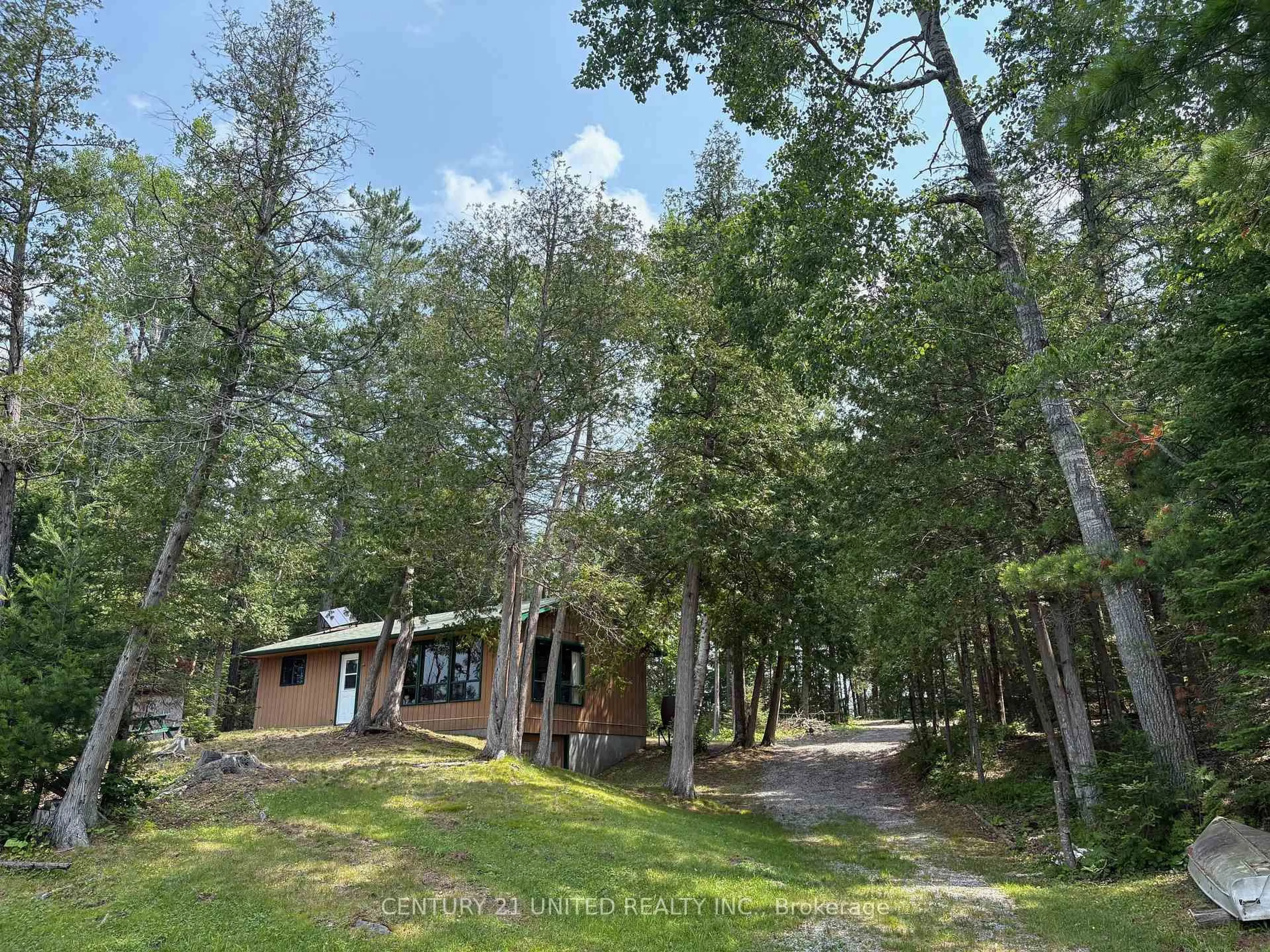 A pic from outside/outdoor area/front of a property/back of a property/a pic from drone, forest/trees view for 16 Fire Route 311, Trent Lakes Ontario K0L 1J0