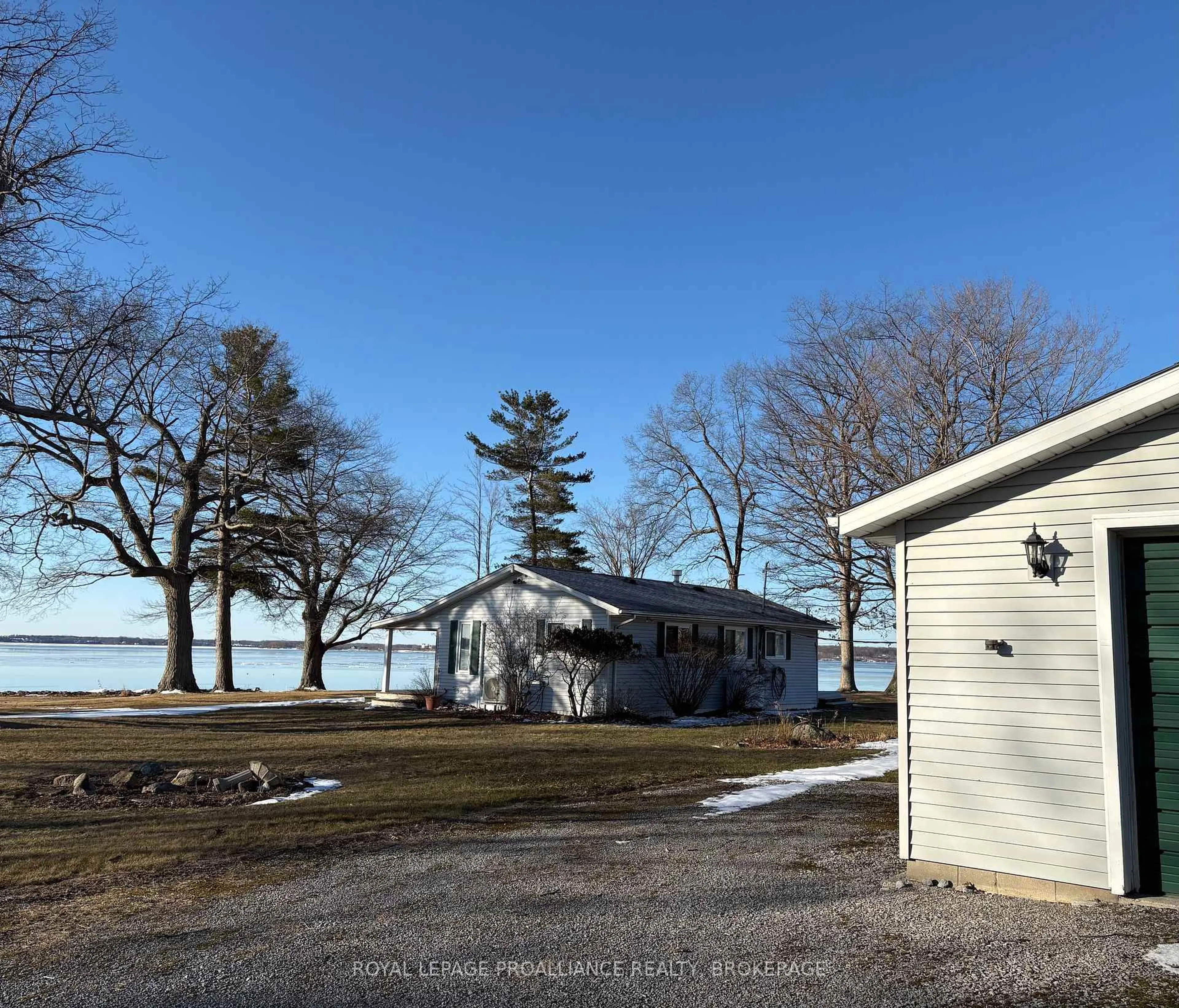 A pic from outside/outdoor area/front of a property/back of a property/a pic from drone, water/lake/river/ocean view for 27 Berry Lane, Wolfe Island Ontario K0H 2Y0