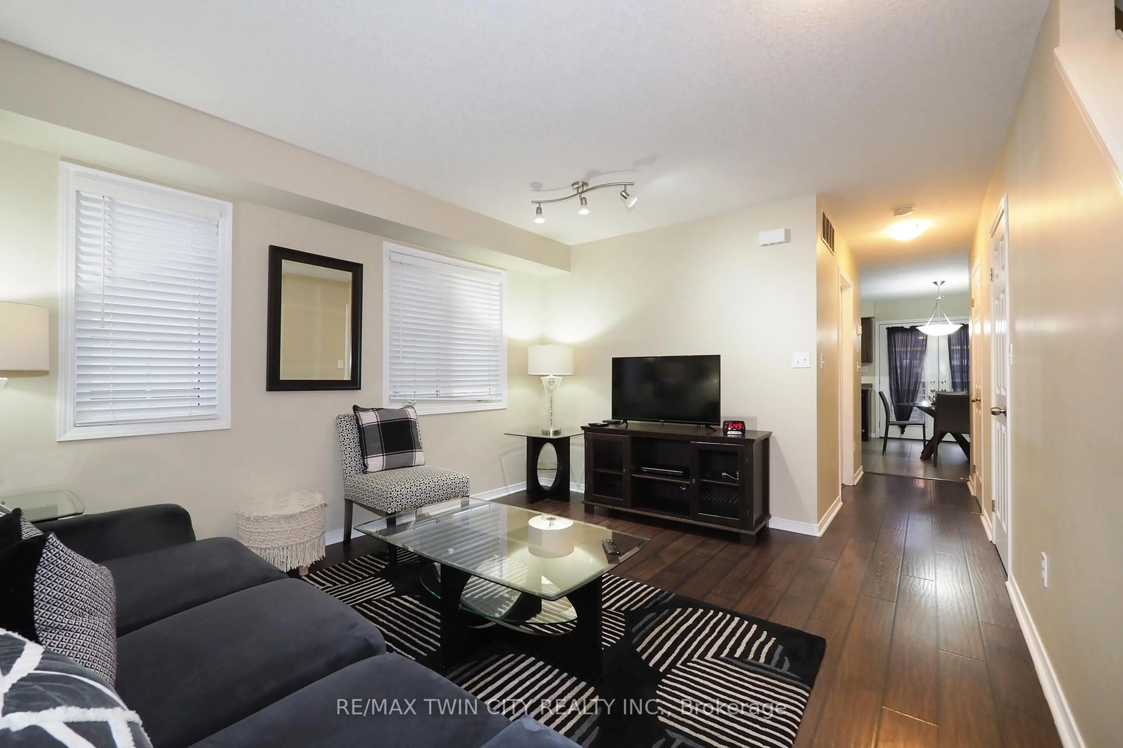 Living room with furniture, wood/laminate floor for 240 Westmeadow Dr #B12, Kitchener Ontario N2N 0A1