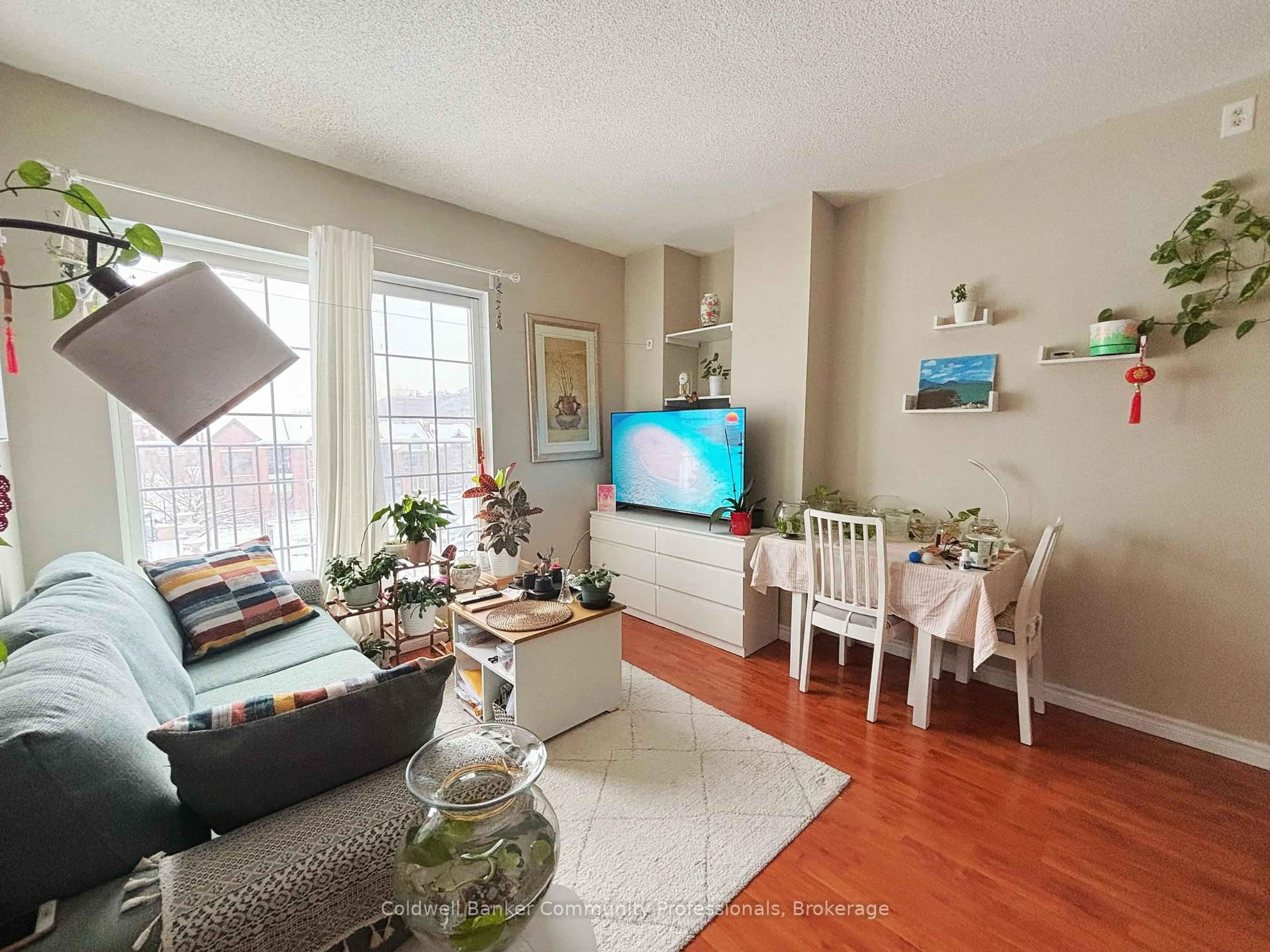 Living room with furniture, wood/laminate floor for 135 James St #304, Hamilton Ontario L8P 2Z6