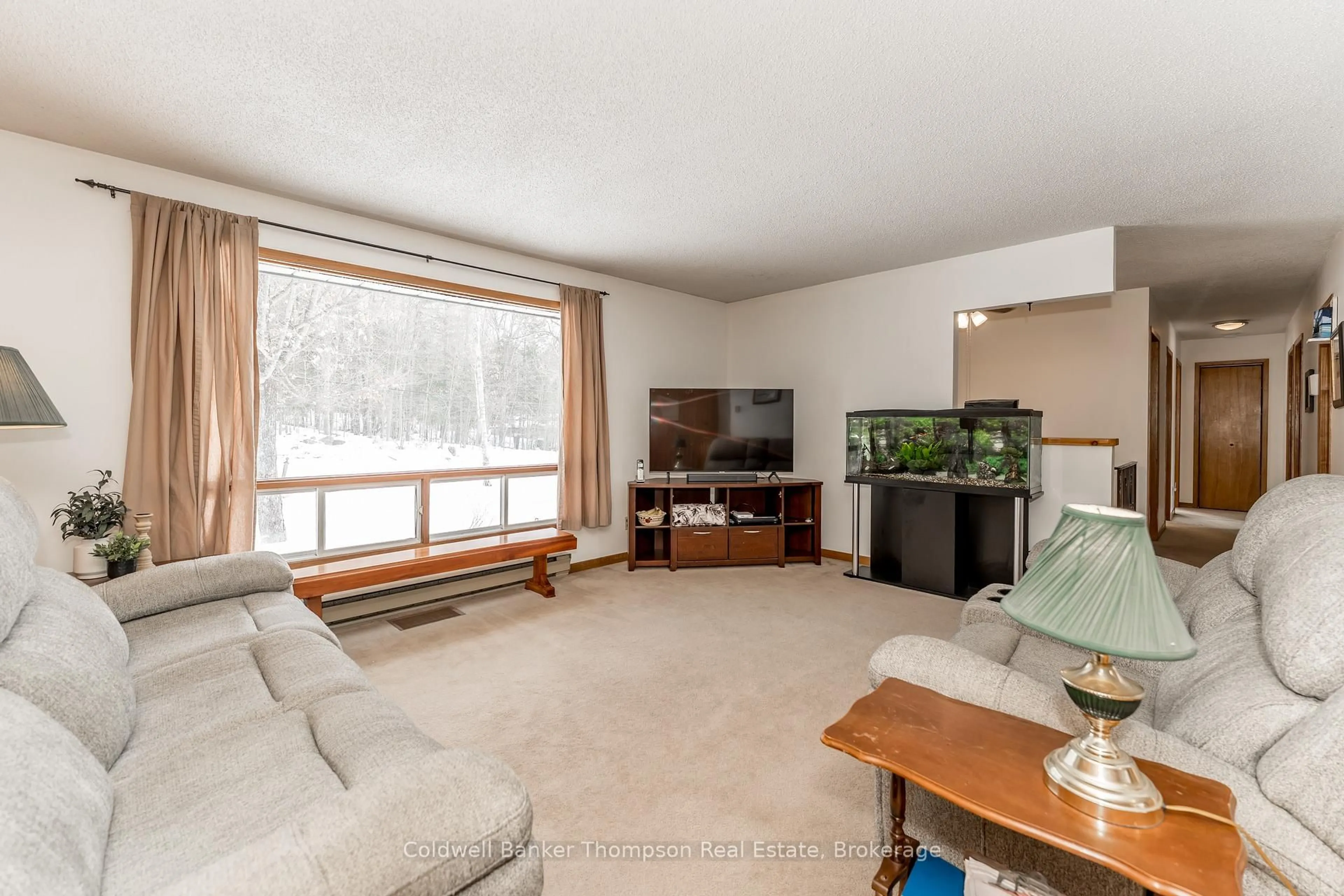 Living room with furniture, wood/laminate floor for 1357 Ravenscliffe Rd, Huntsville Ontario P1H 2N5