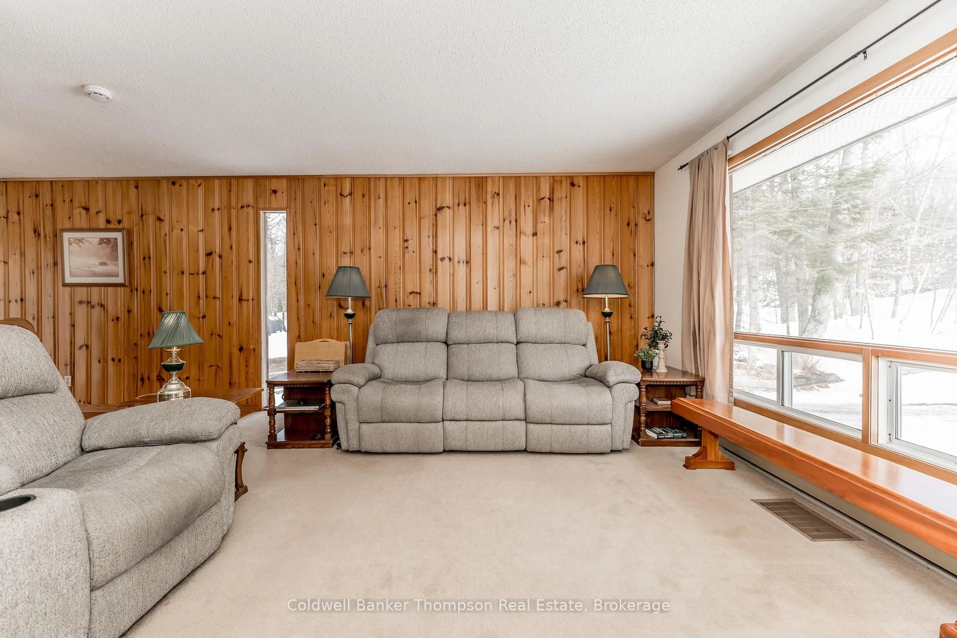 Living room with furniture, wood/laminate floor for 1357 Ravenscliffe Rd, Huntsville Ontario P1H 2N5