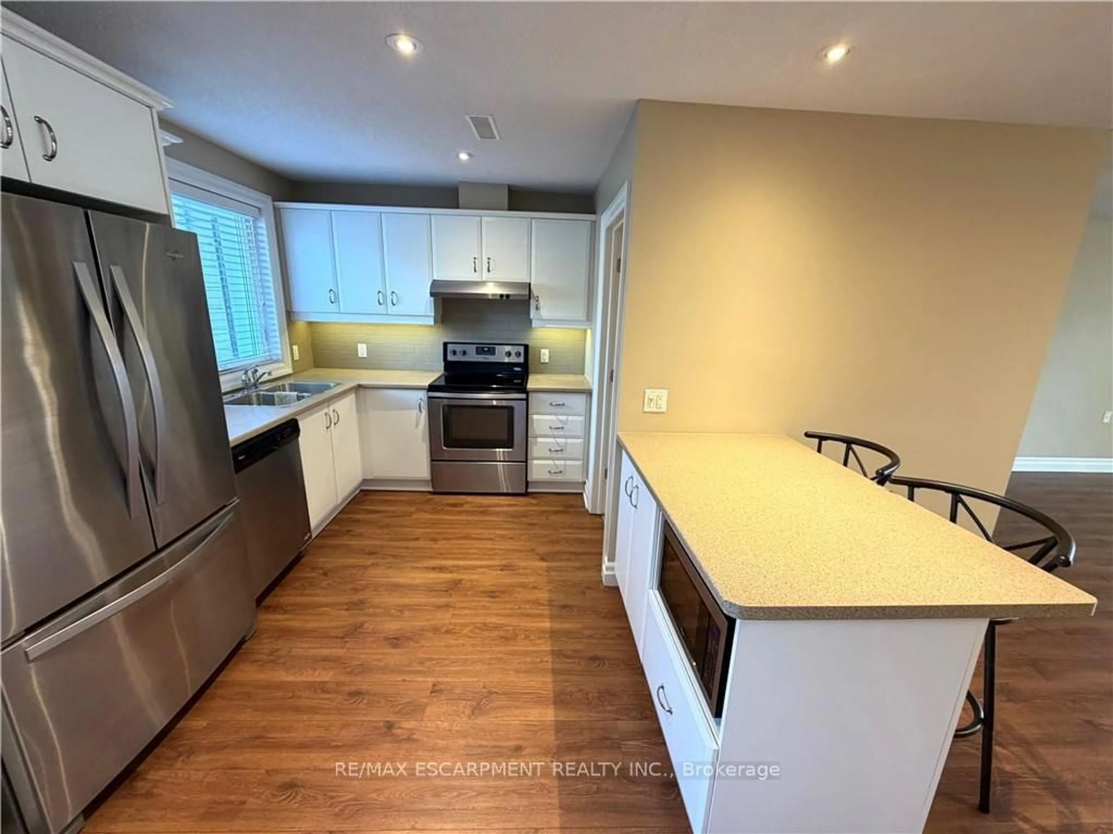 Open concept kitchen, wood/laminate floor for 5 Jaczenko Terr, Hamilton Ontario L9B 1T8