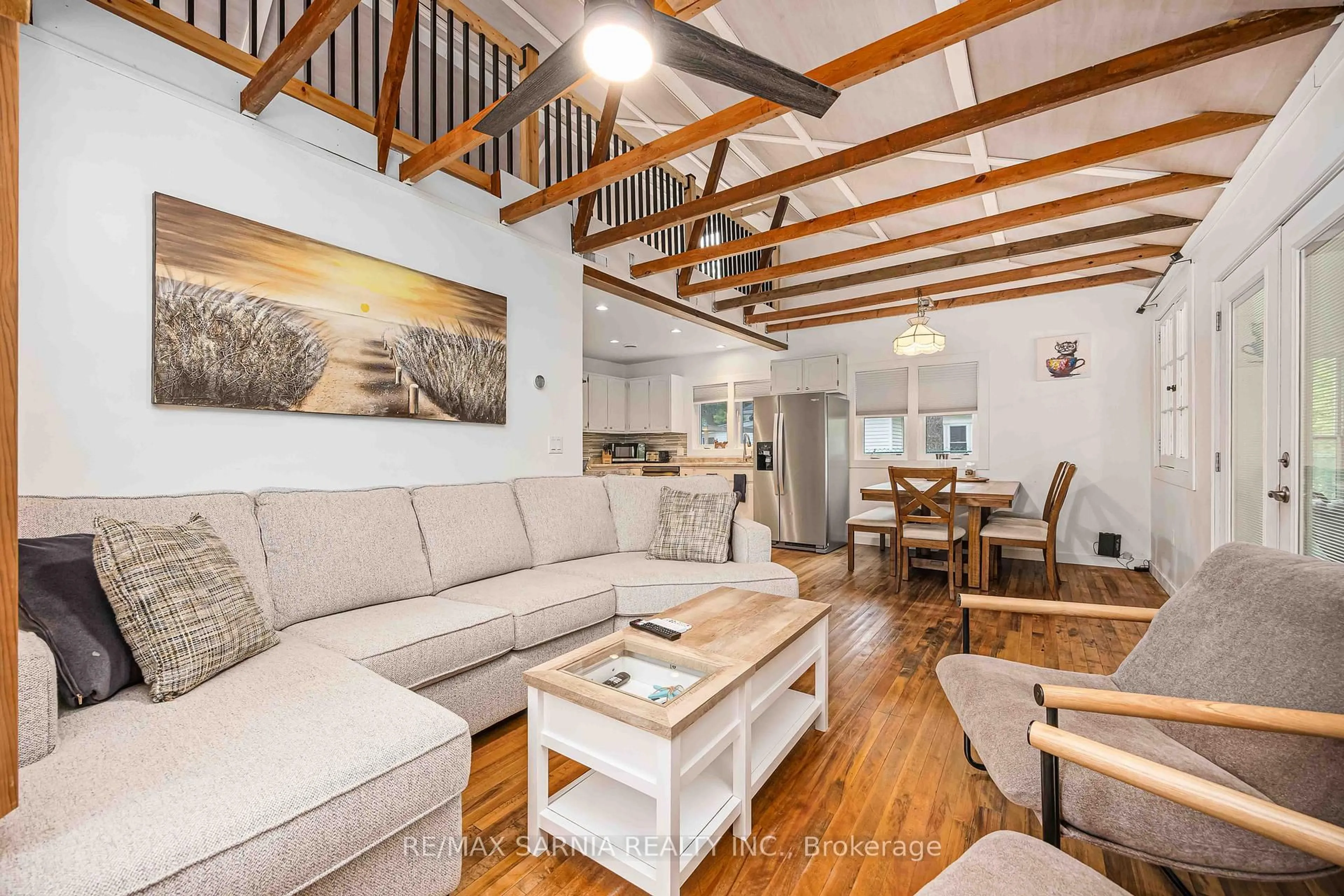 Living room with furniture, wood/laminate floor for 7790 Gallie St, Plympton-Wyoming Ontario N0N 1J6