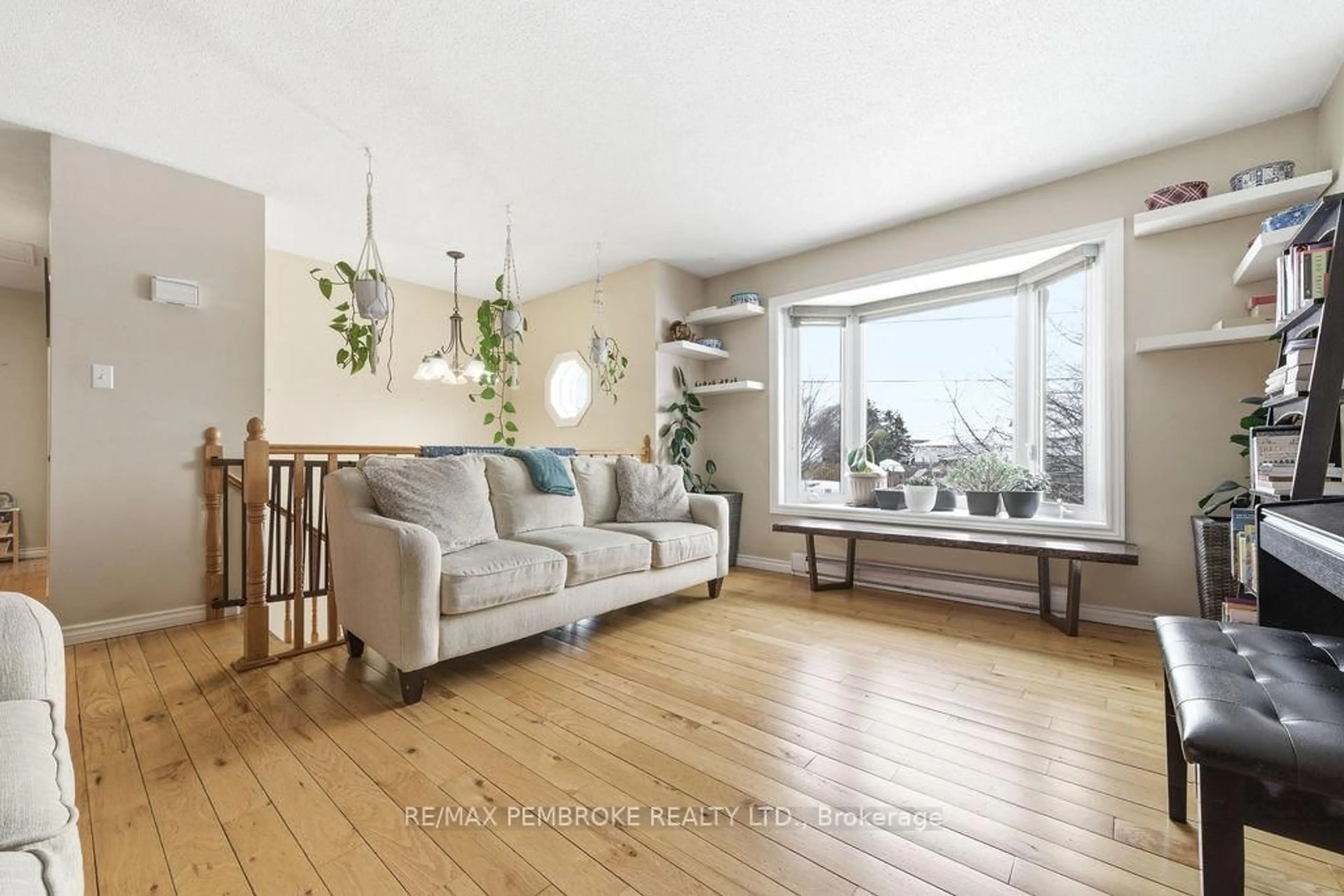 Living room with furniture, wood/laminate floor for 4 Dutch Dr, Petawawa Ontario K8H 3M2