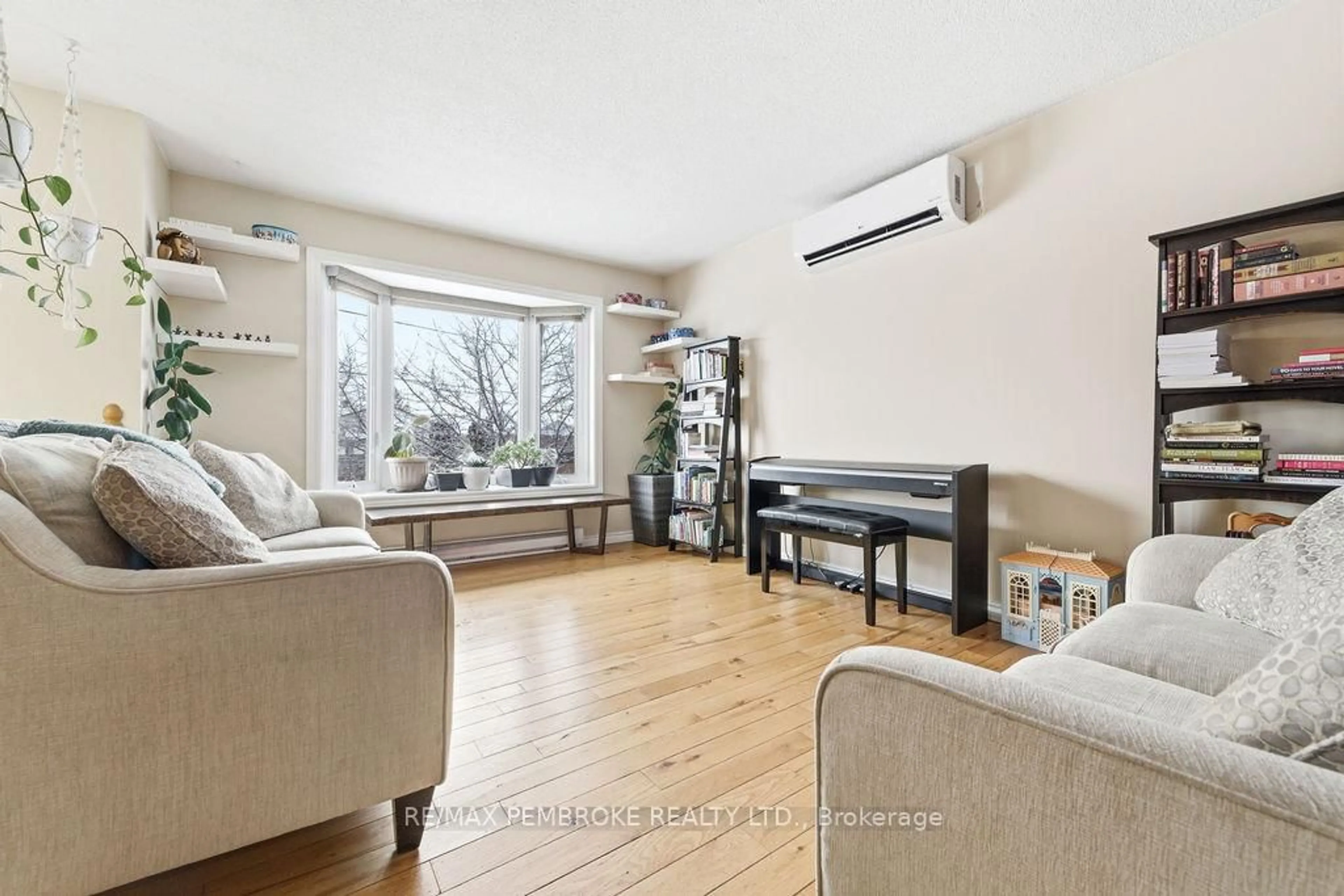 Living room with furniture, wood/laminate floor for 4 Dutch Dr, Petawawa Ontario K8H 3M2