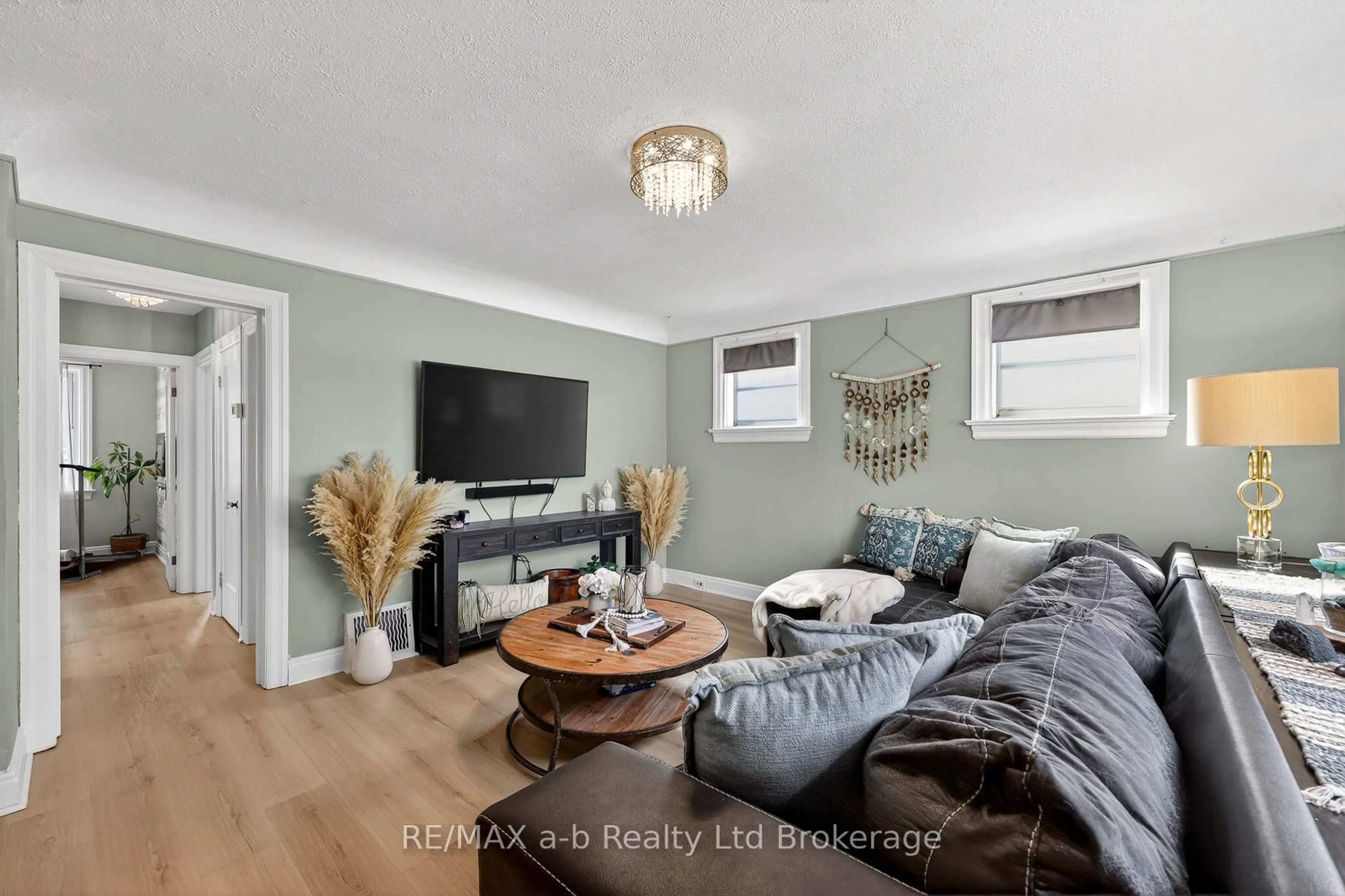 Living room with furniture, wood/laminate floor for 27 Fyfe Ave, Woodstock Ontario N4S 3S5