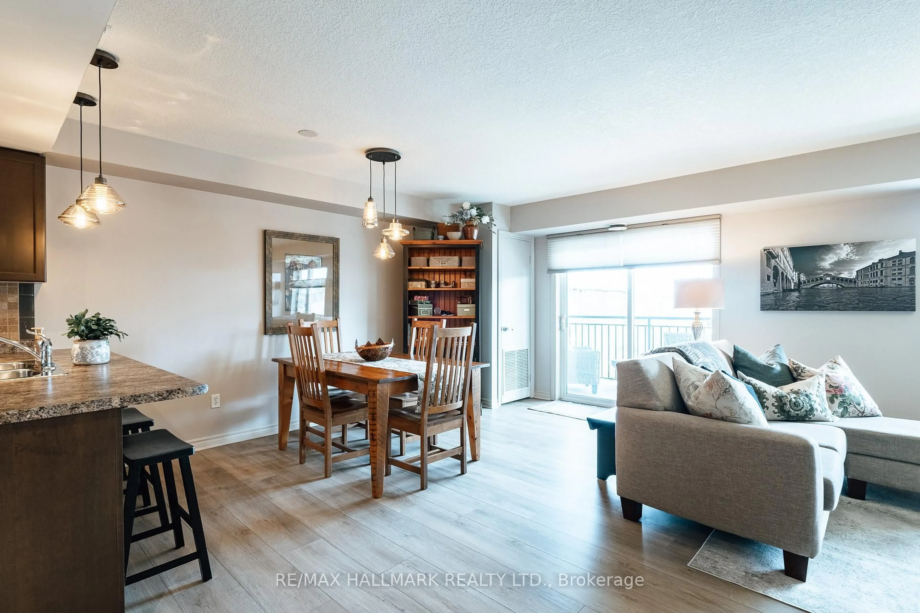 Living room with furniture, wood/laminate floor for 39 Goodwin Dr #408, Guelph Ontario N1L 0E5