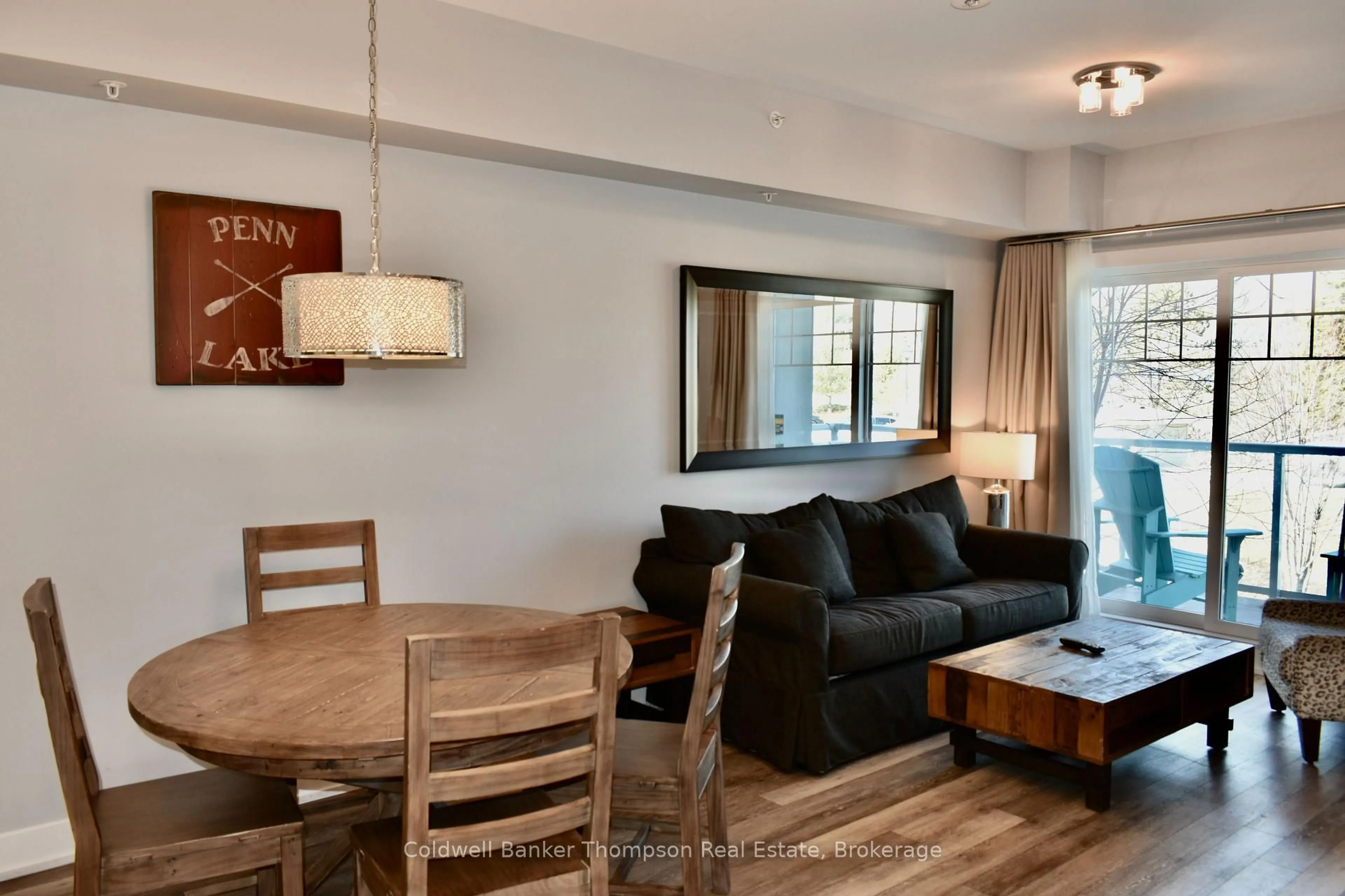 Living room with furniture, wood/laminate floor for 25 PEN LAKE POINT Rd #216, Huntsville Ontario P1H 1A9