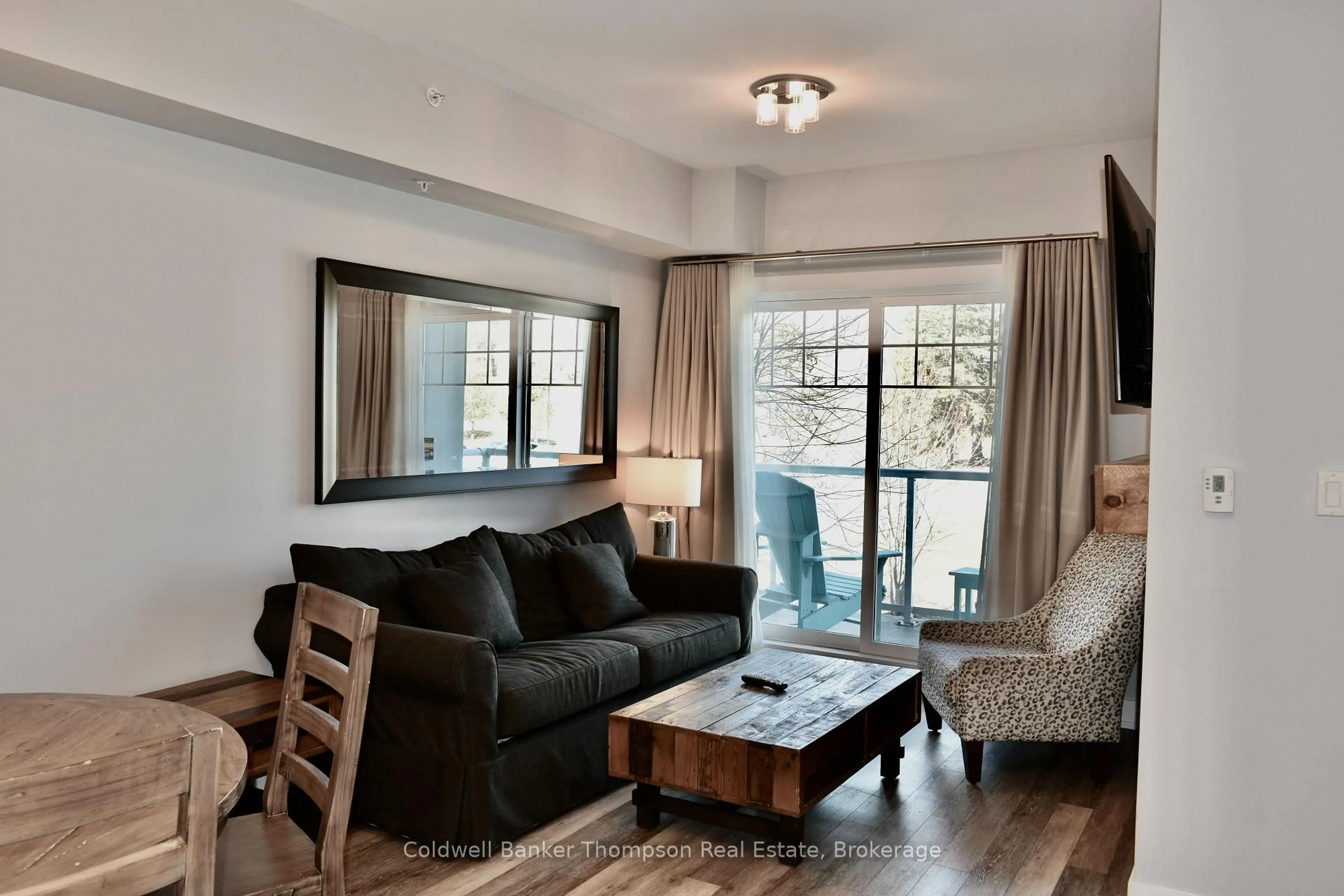 Living room with furniture, wood/laminate floor for 25 PEN LAKE POINT Rd #216, Huntsville Ontario P1H 1A9