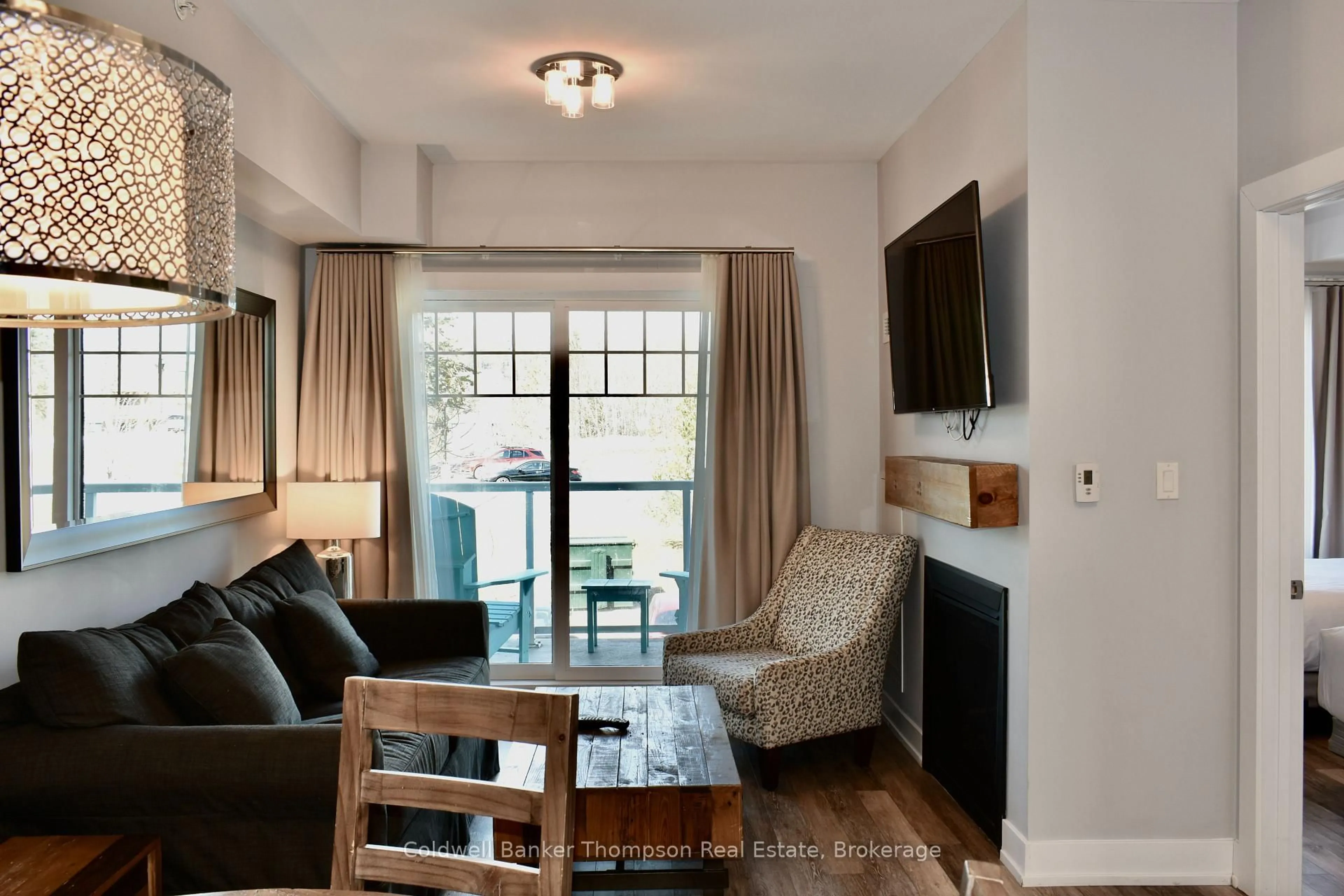 Living room with furniture, wood/laminate floor for 25 PEN LAKE POINT Rd #216, Huntsville Ontario P1H 1A9