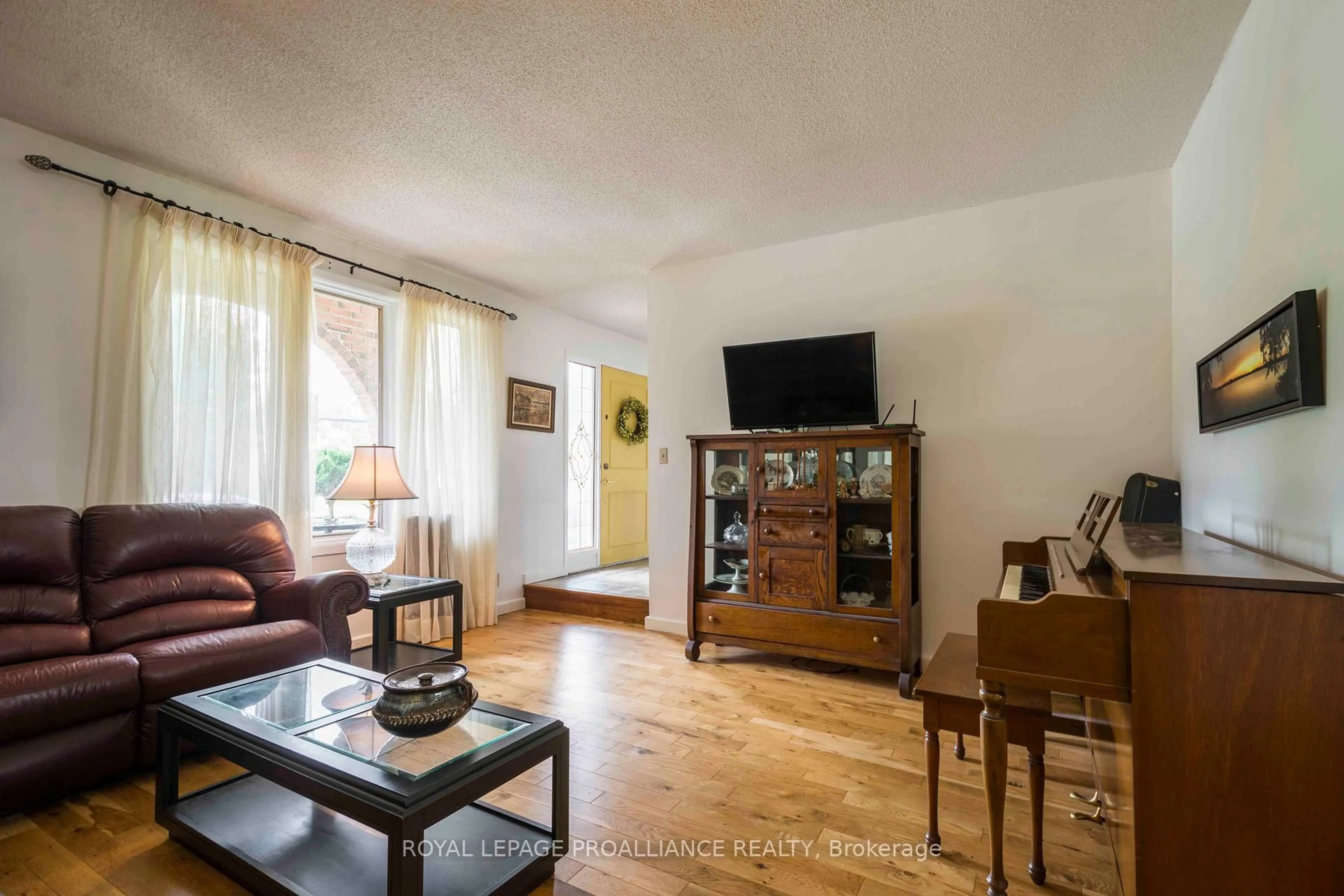 Living room with furniture, wood/laminate floor for 12 Montrose Rd, Quinte West Ontario K8R 1A3