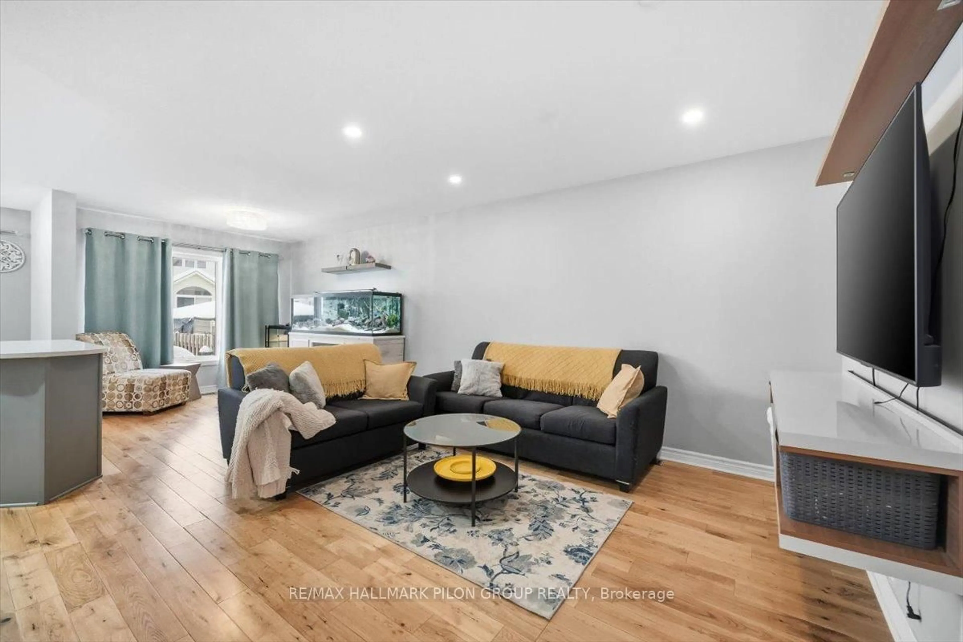 Living room with furniture, wood/laminate floor for 504 Allegro Way, Ottawa Ontario K4A 0H6