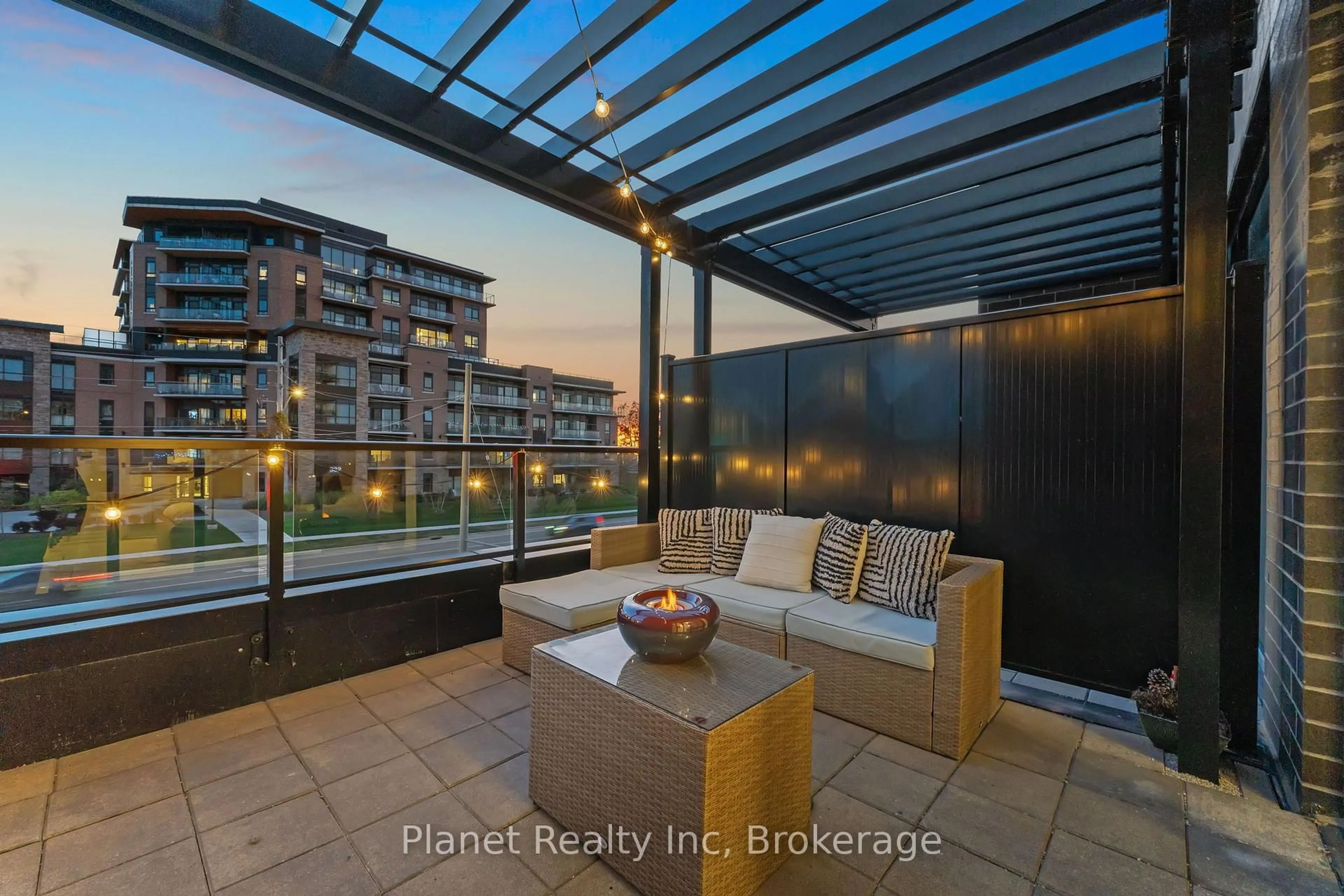 Patio, city buildings view from balcony for 1878 Gordon St #103, Guelph Ontario N1L 0P4