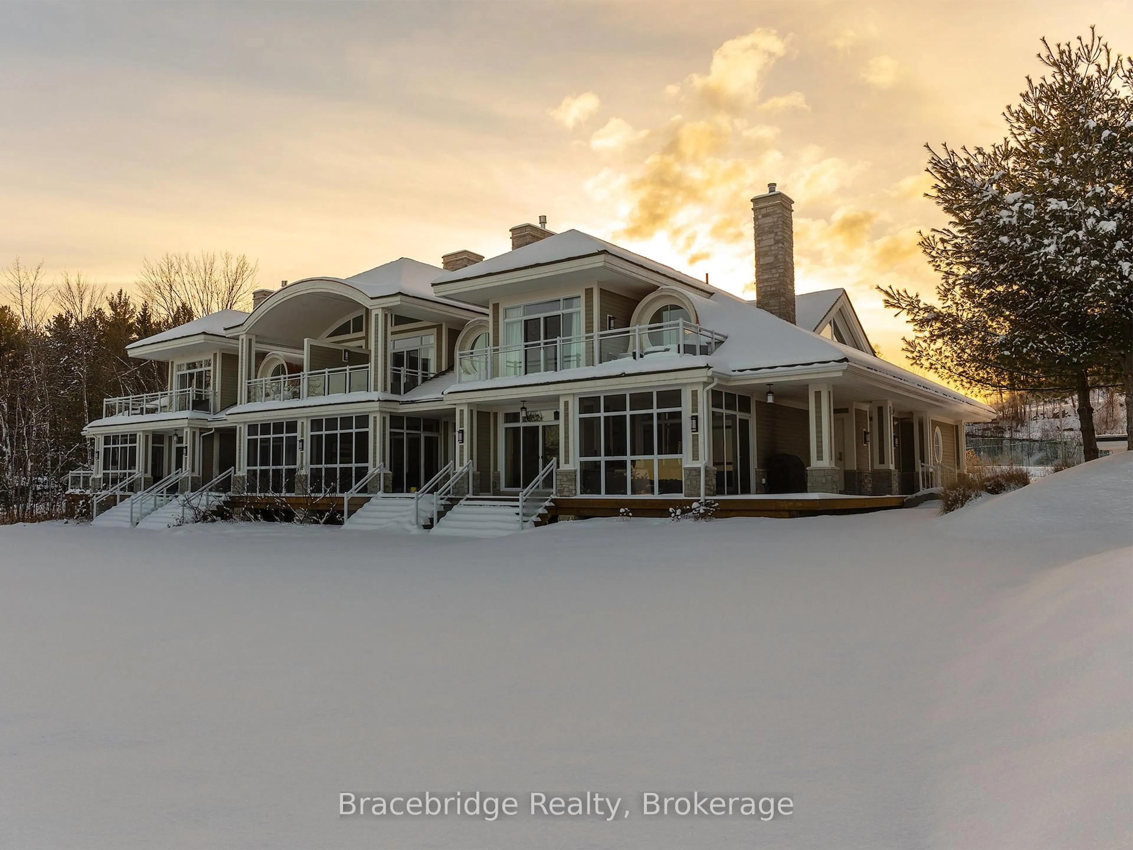 A pic from outside/outdoor area/front of a property/back of a property/a pic from drone, mountain view for 1869 Muskoka Road 118 Highway #G102-C2, Muskoka Lakes Ontario P1L 1W8