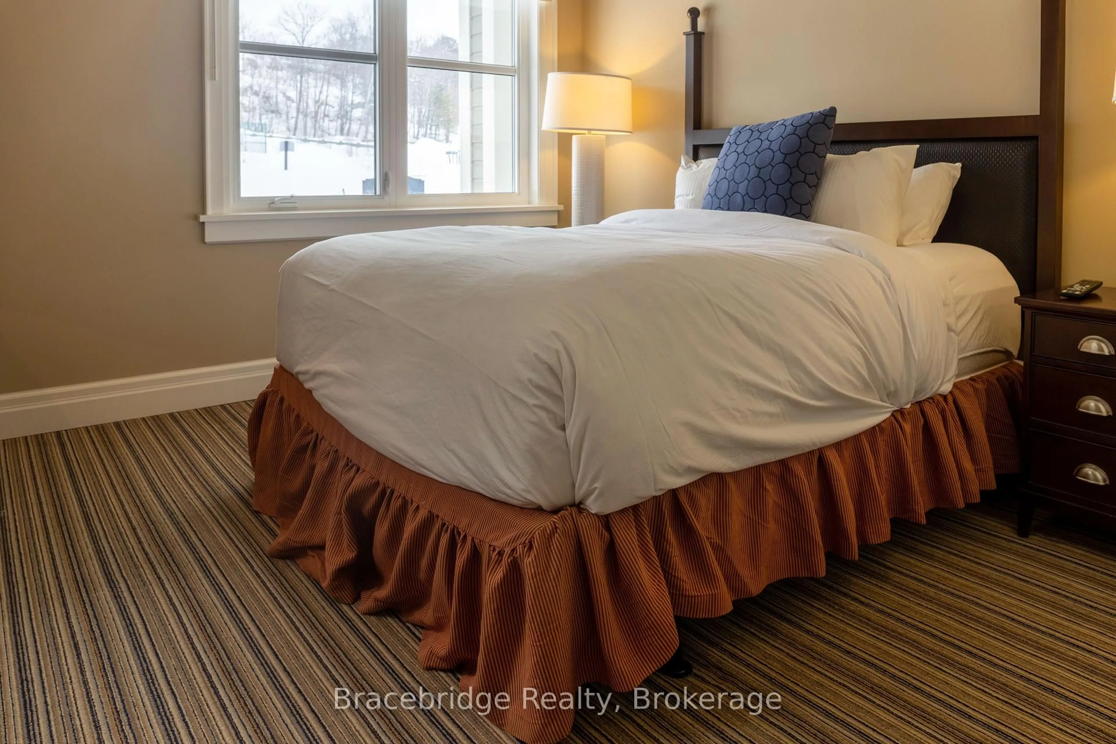 Bedroom with bed, carpet floor for 1869 Muskoka Road 118 Highway #G102-C2, Muskoka Lakes Ontario P1L 1W8