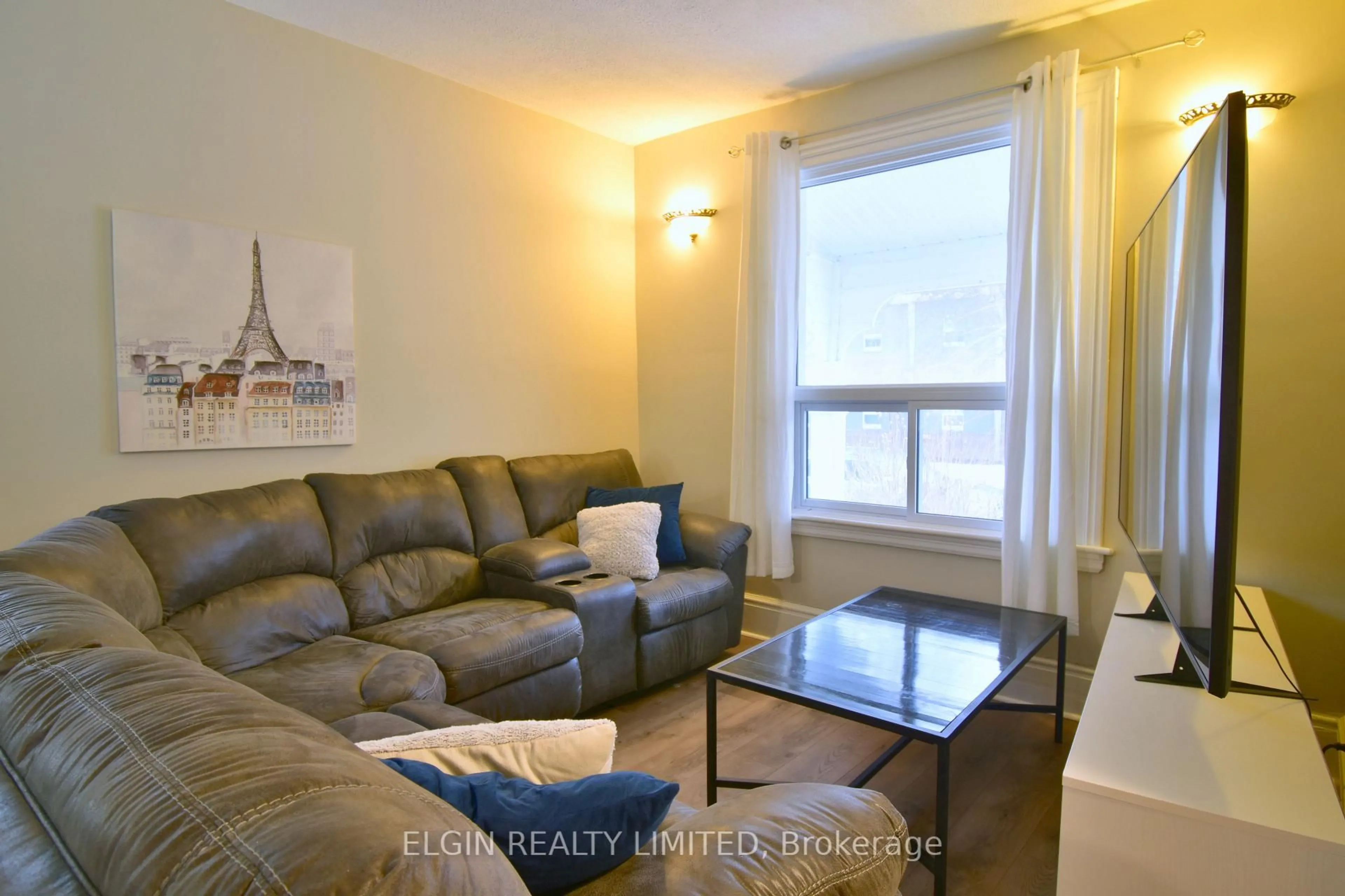 Living room with furniture, wood/laminate floor for 57 Scott St, St. Thomas Ontario N5P 1K7