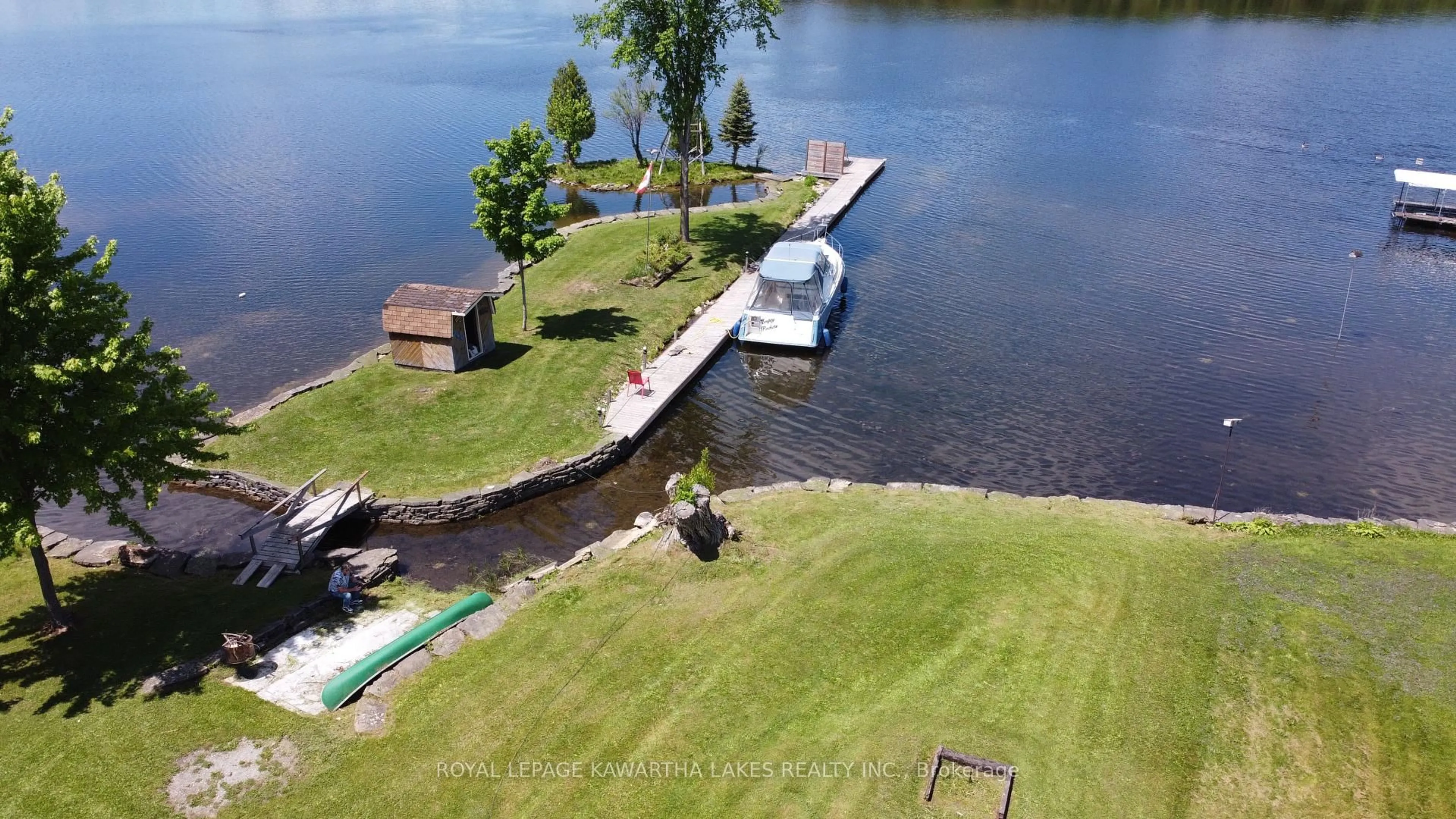 A pic from outside/outdoor area/front of a property/back of a property/a pic from drone, water/lake/river/ocean view for 63 Robinson Ave, Kawartha Lakes Ontario K0M 2B0