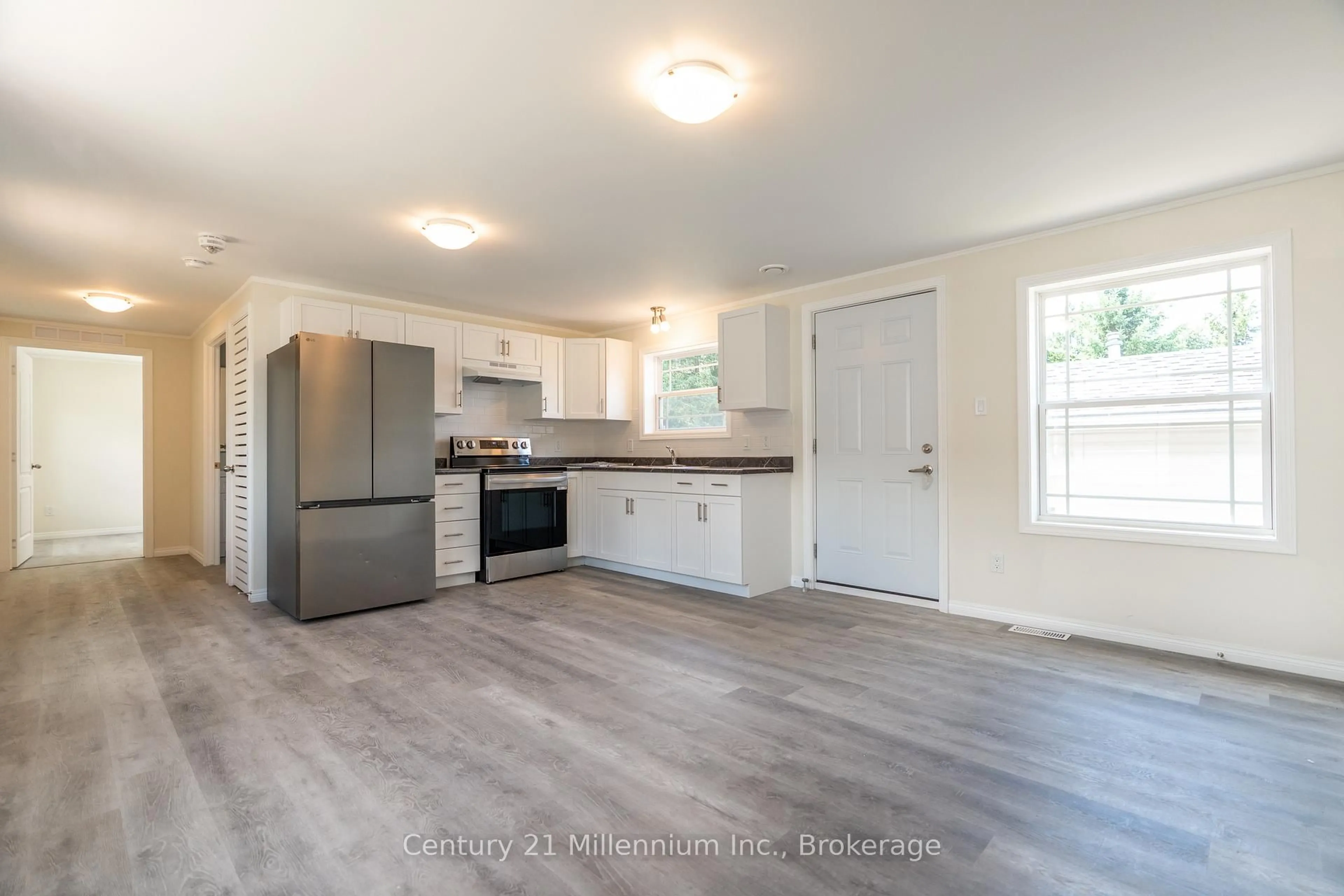 Open concept kitchen, wood/laminate floor for 8 Sussex Sq, Georgian Bluffs Ontario N4K 5N5
