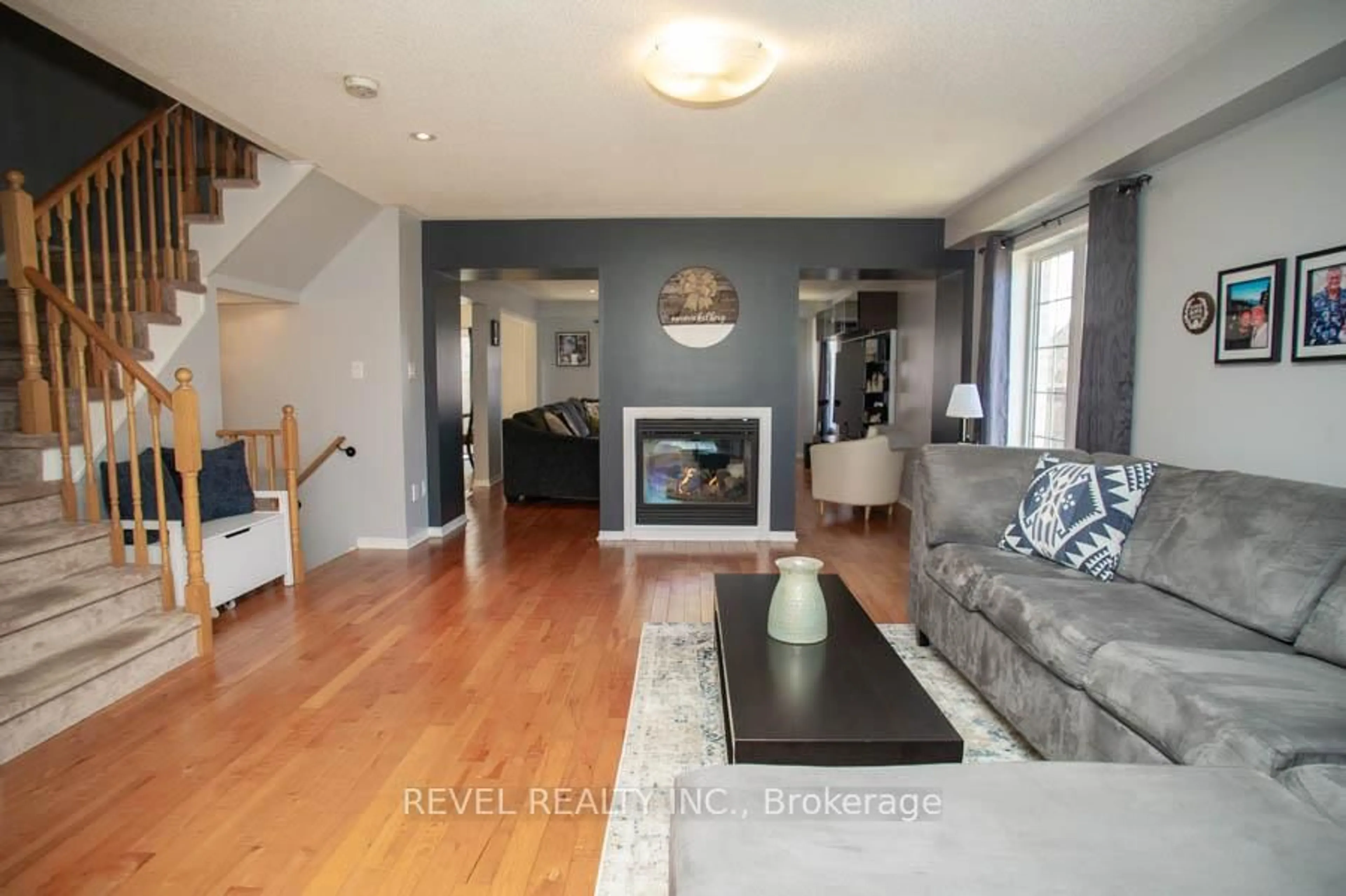 Living room with furniture, wood/laminate floor for 28 Barrett Ave, Brantford Ontario N3S 0B5