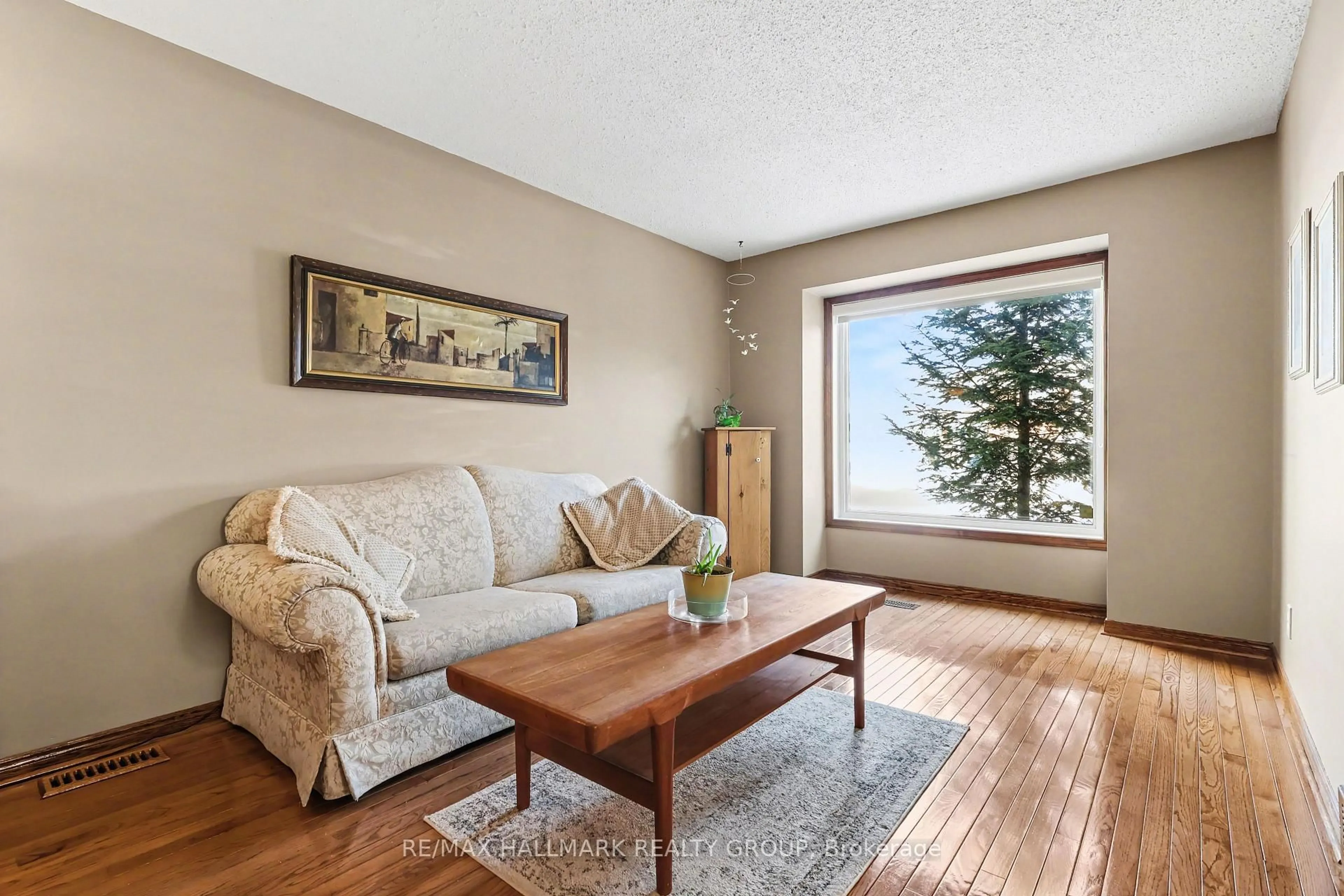 Living room with furniture, wood/laminate floor for 1620 Des Grives Cres, Orleans Ontario K1C 5B7