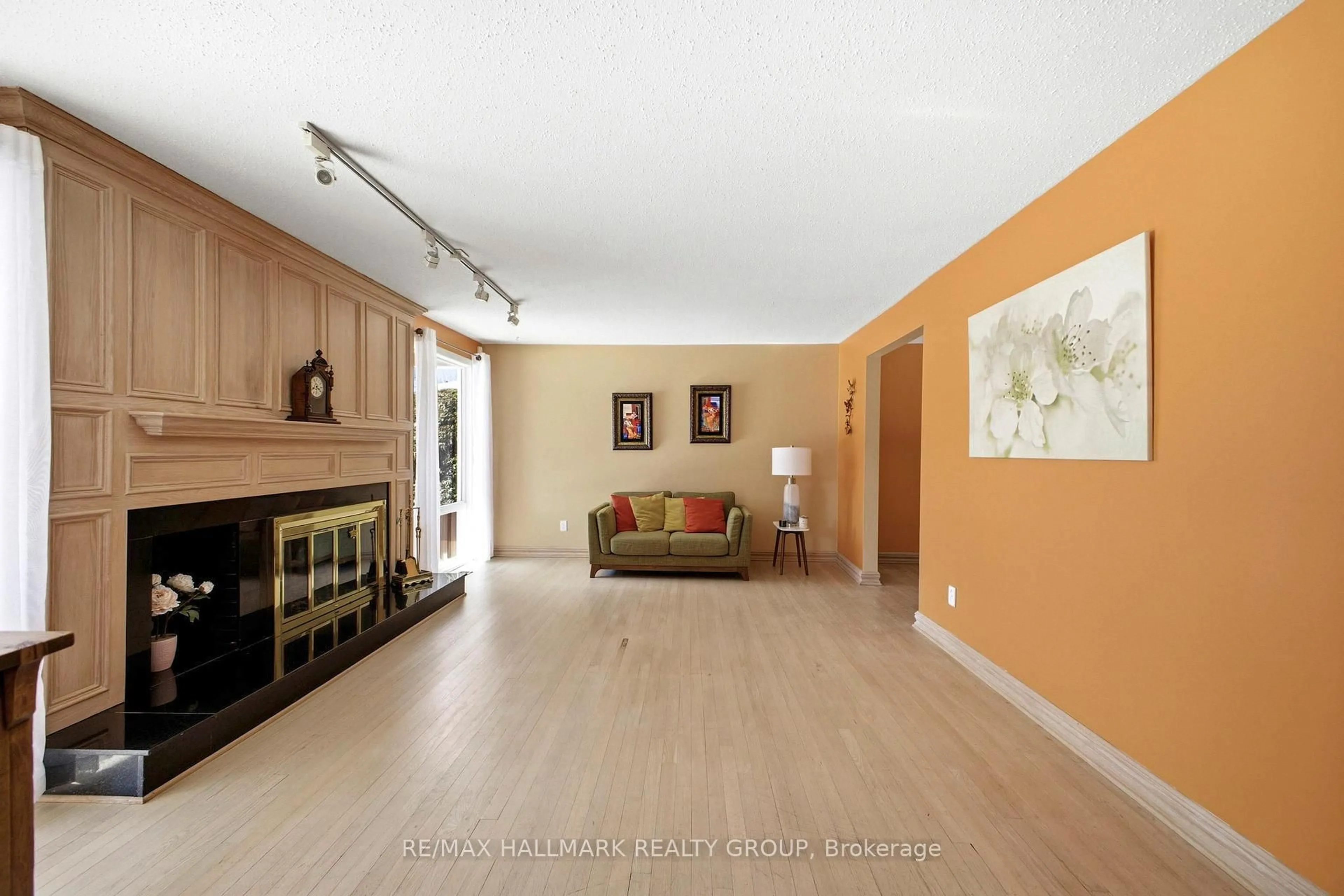 Living room with furniture, wood/laminate floor for 59 Ashgrove Cres, Ottawa Ontario K2G 0S8