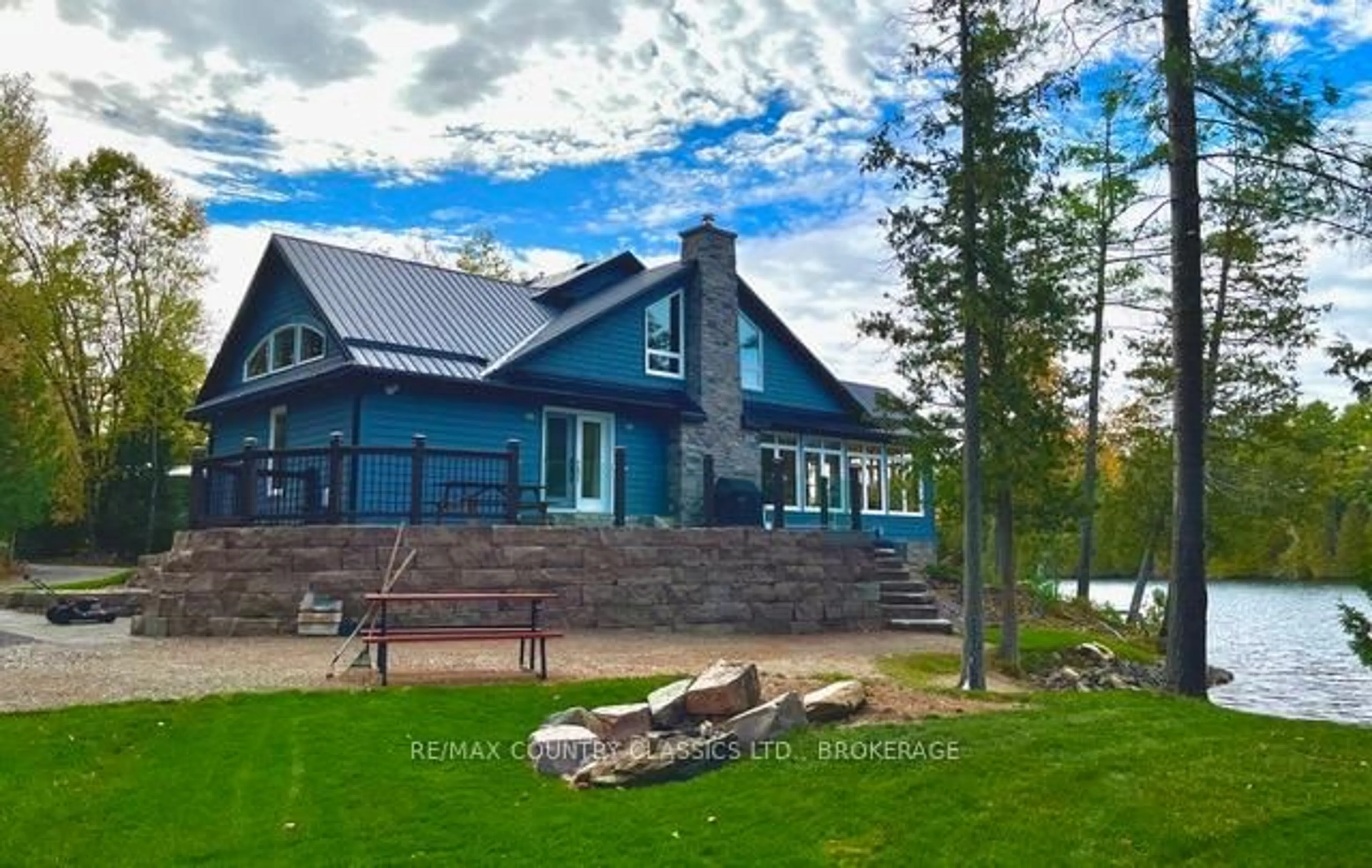 A pic from outside/outdoor area/front of a property/back of a property/a pic from drone, water/lake/river/ocean view for 1021 South Kash Lake Lane, Arden Ontario K0H 1B0