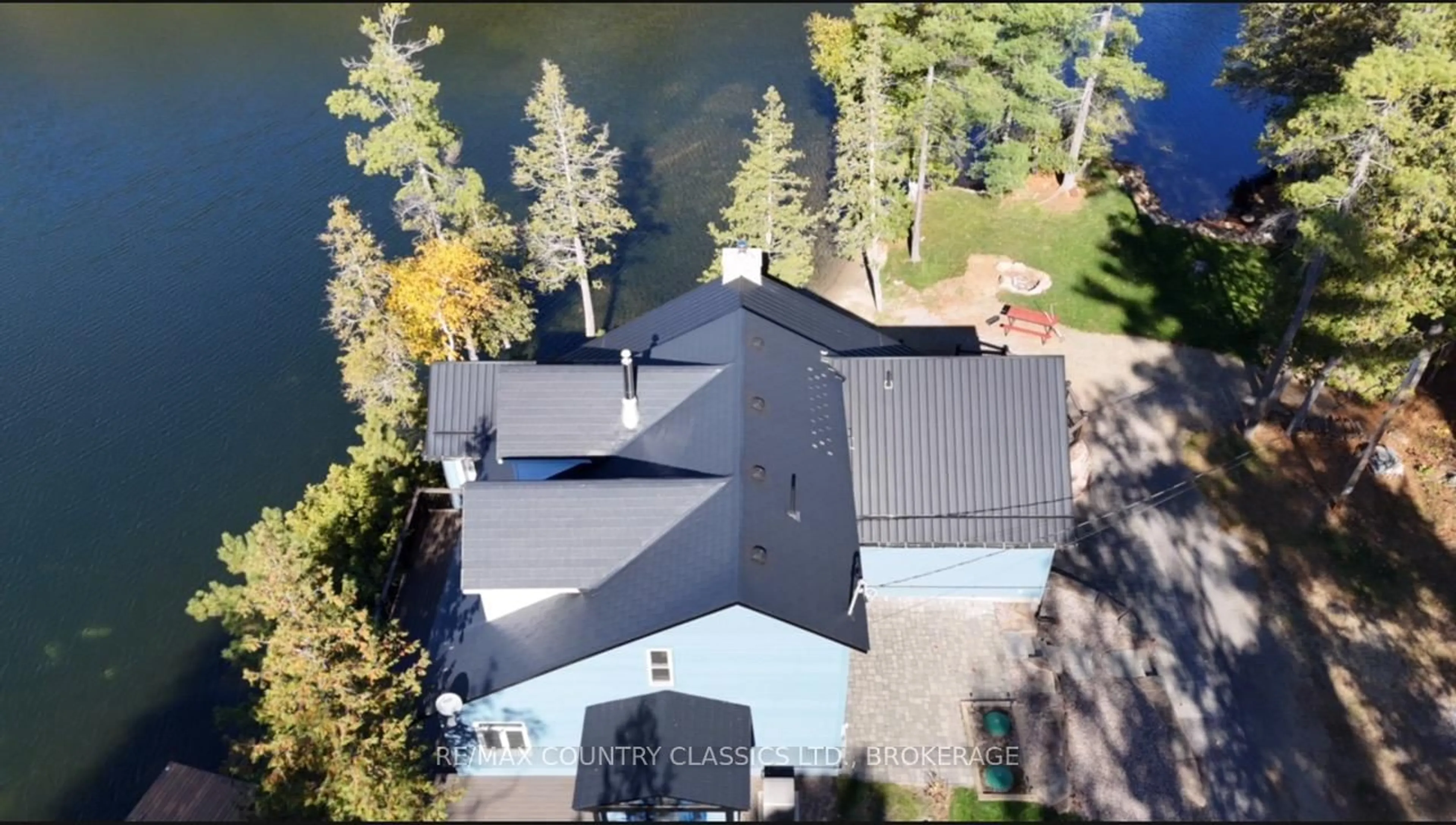 A pic from outside/outdoor area/front of a property/back of a property/a pic from drone, water/lake/river/ocean view for 1021 South Kash Lake Lane, Arden Ontario K0H 1B0