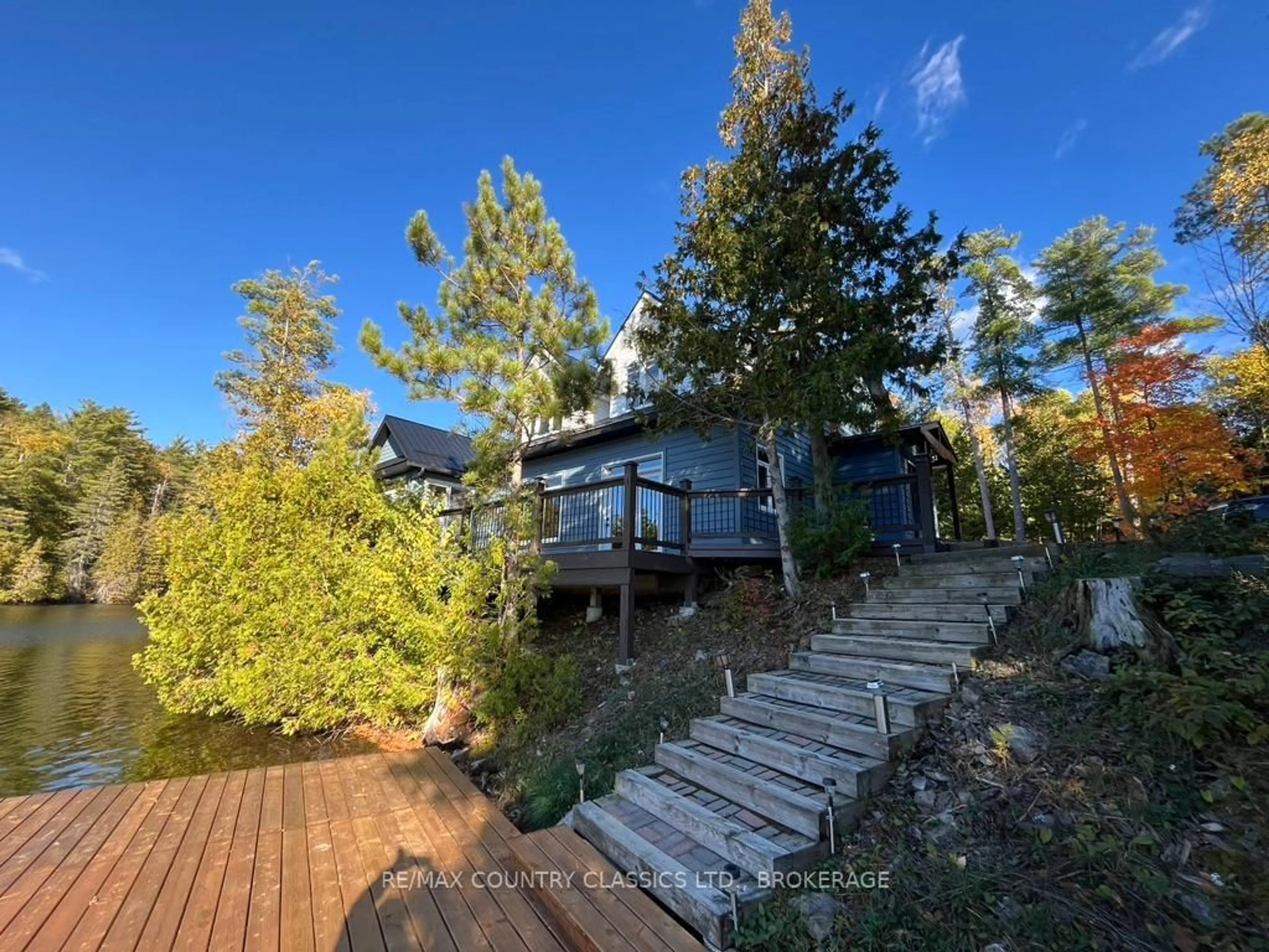 A pic from outside/outdoor area/front of a property/back of a property/a pic from drone, forest/trees view for 1021 South Kash Lake Lane, Arden Ontario K0H 1B0