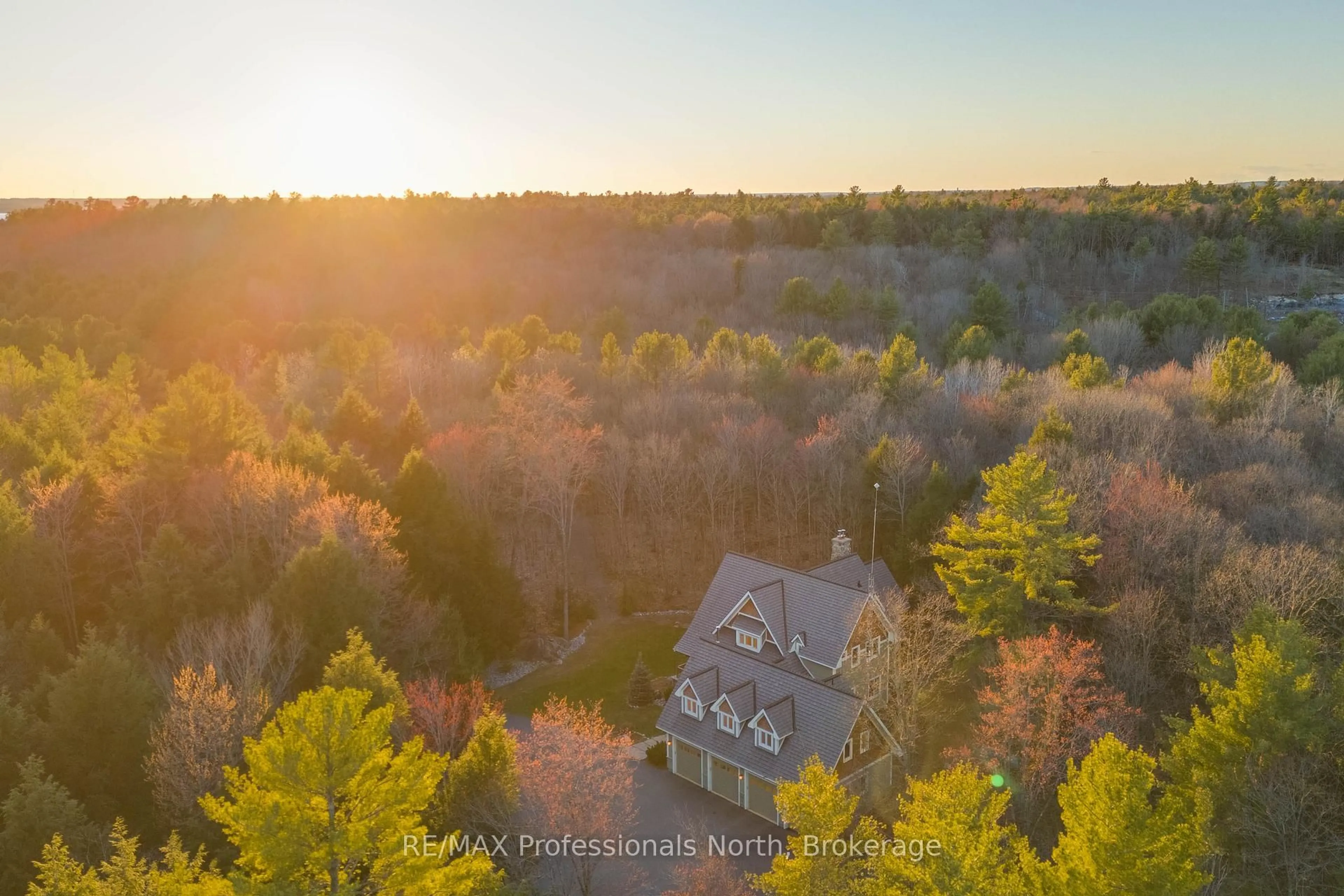 A pic from outside/outdoor area/front of a property/back of a property/a pic from drone, forest/trees view for 1656 MUSKOKA BEACH Rd, Bracebridge Ontario P1P 1R1