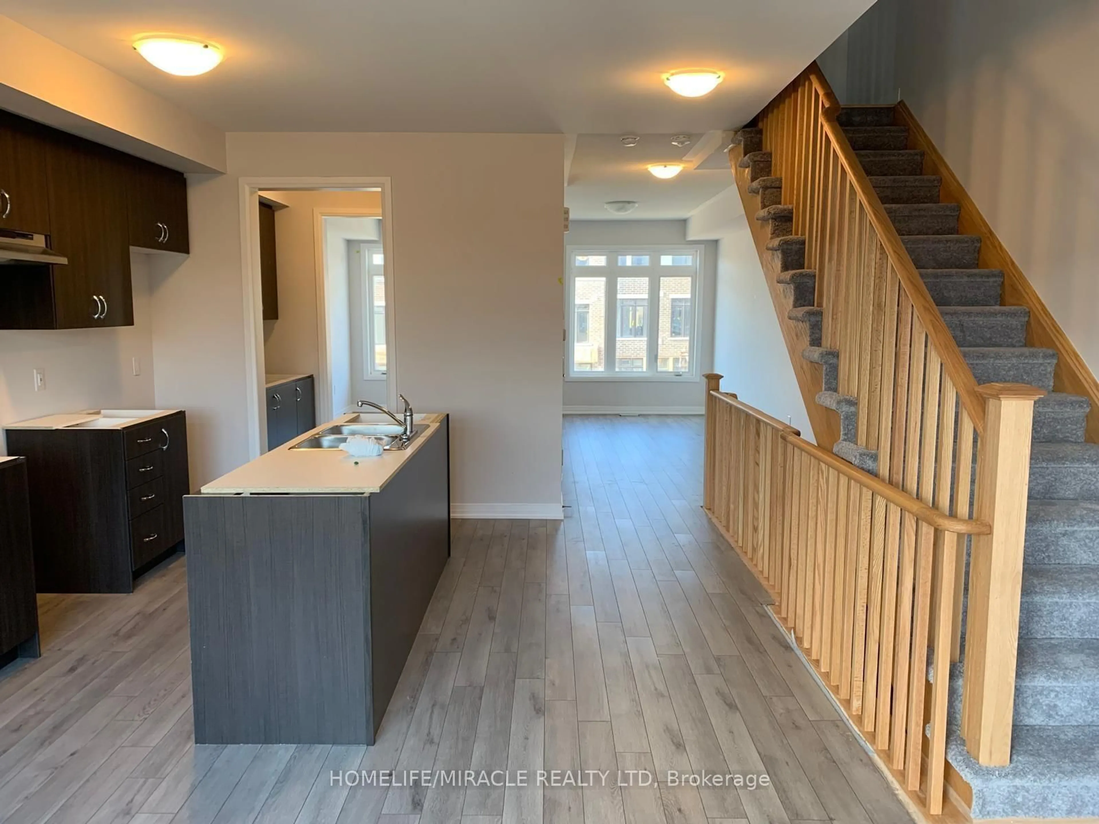 Open concept kitchen, wood/laminate floor for 585 Colborne St #109, Brantford Ontario N3S 0K4