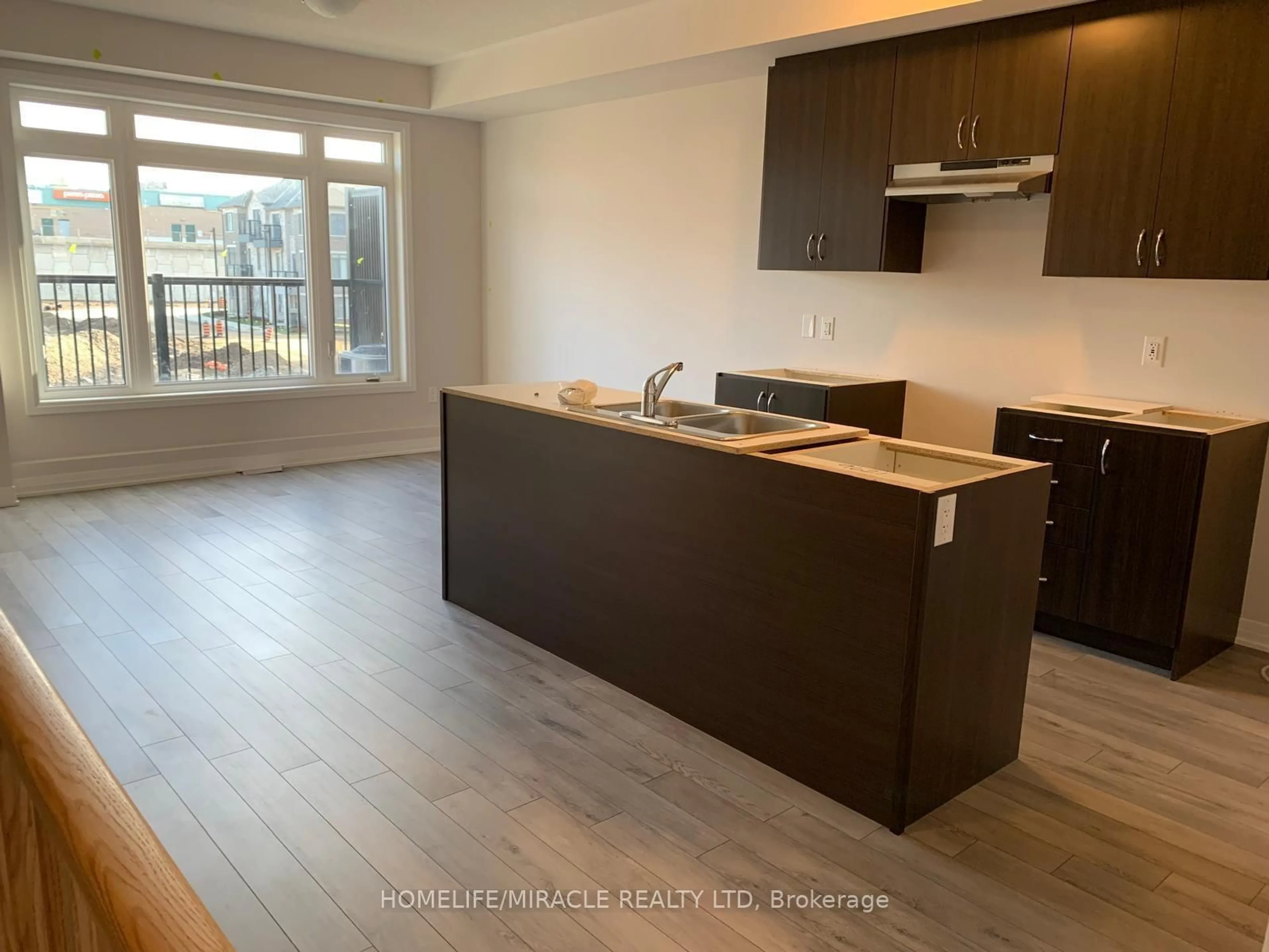 Open concept kitchen, wood/laminate floor for 585 Colborne St #109, Brantford Ontario N3S 0K4