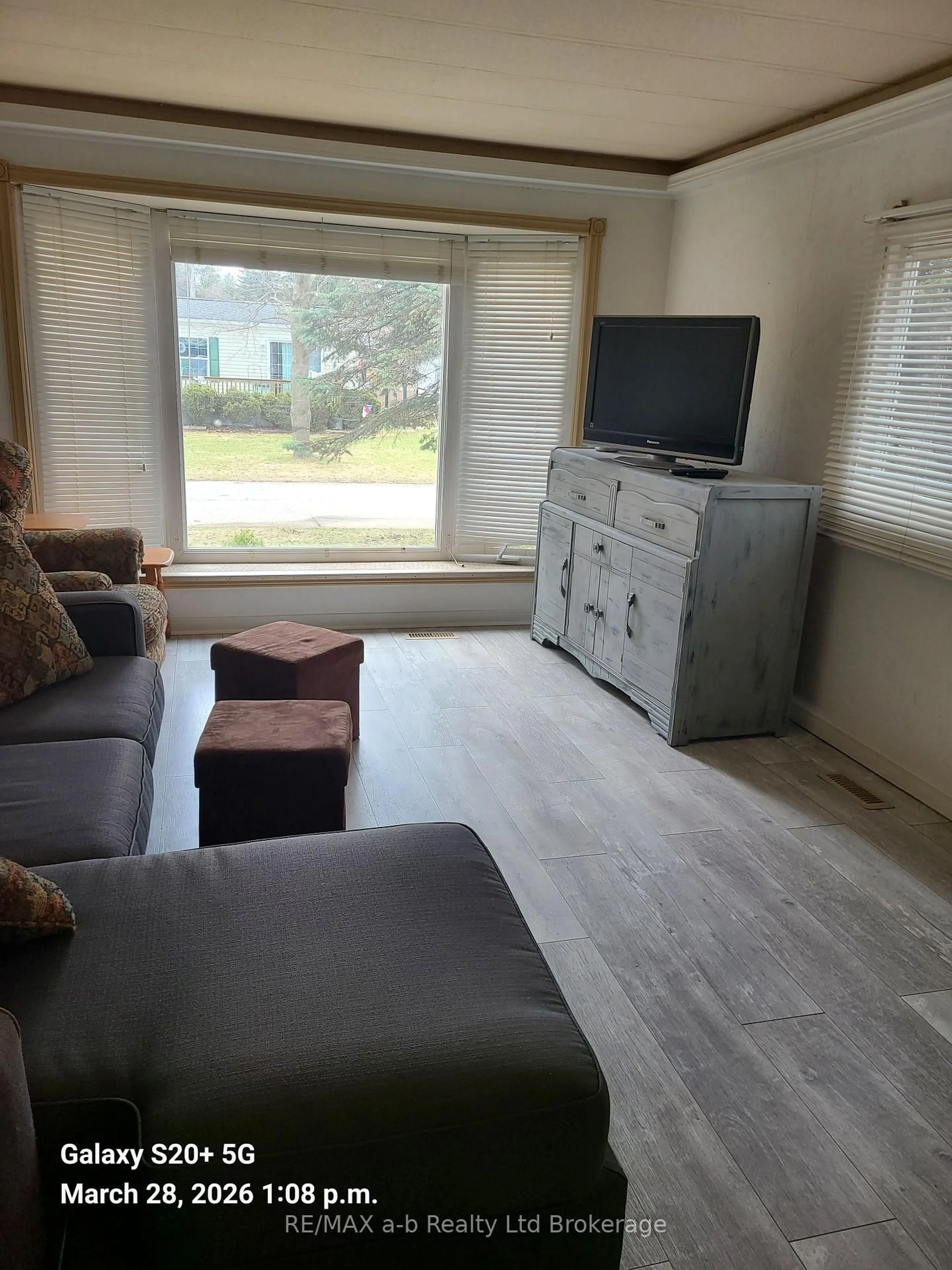 Living room with furniture, wood/laminate floor for 746112 Township Road 4 Rd #15, Blandford-Blenheim Ontario N4S 7V9