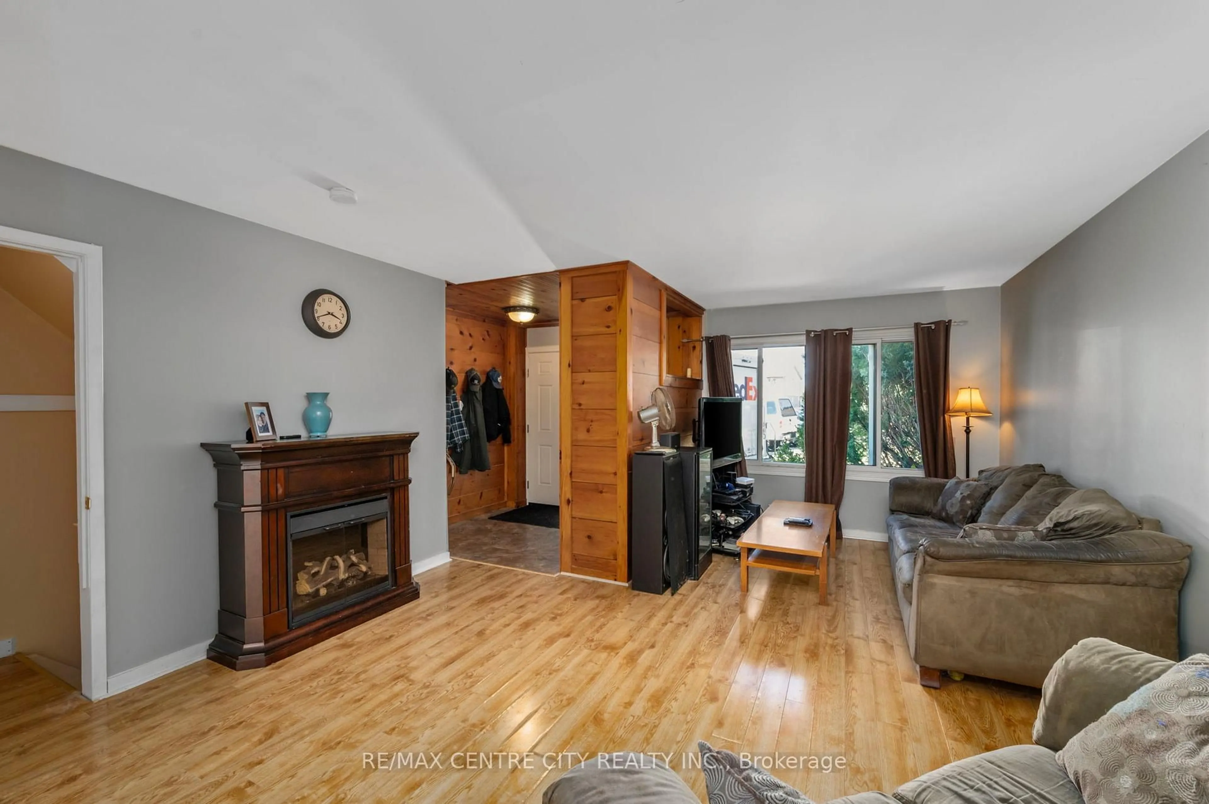 Living room with furniture, wood/laminate floor for 690 Little Grey St #110, London East Ontario N5Z 4M9