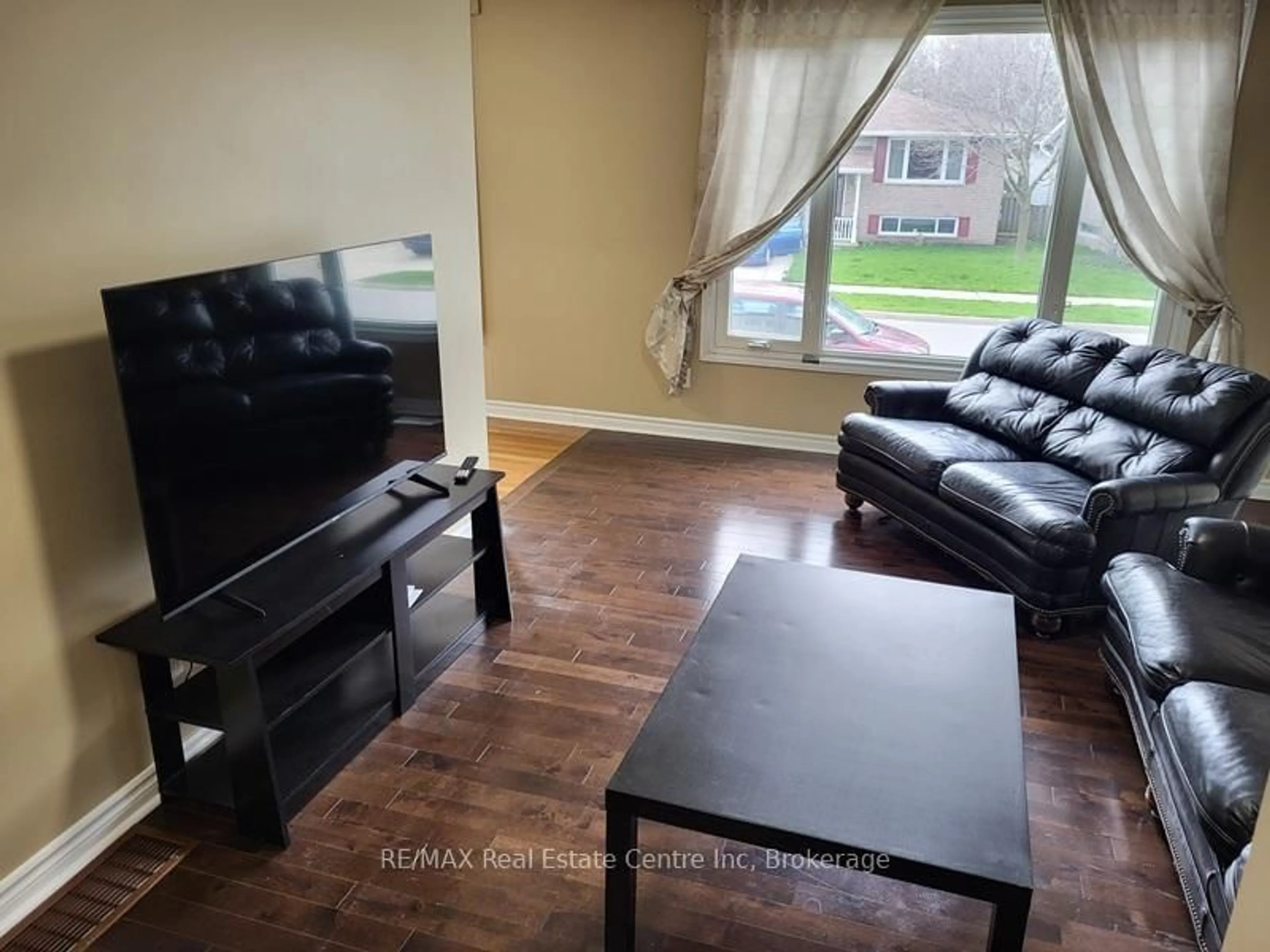 Living room with furniture, wood/laminate floor for 9 Sanderson Dr, Guelph Ontario N1H 6T7
