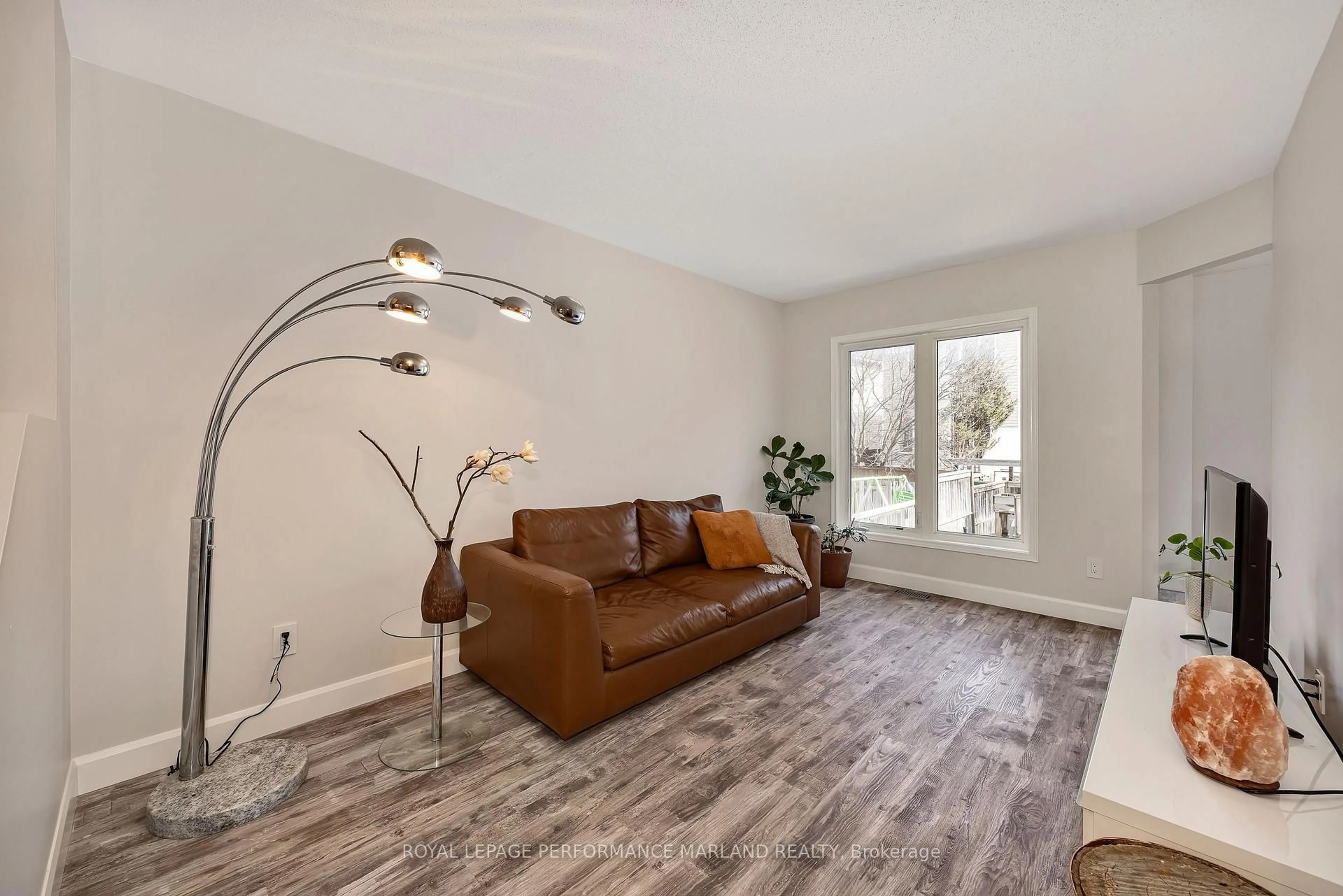 Living room with furniture, wood/laminate floor for 63 Madaket Private #18, Ottawa Ontario K2M 3B1