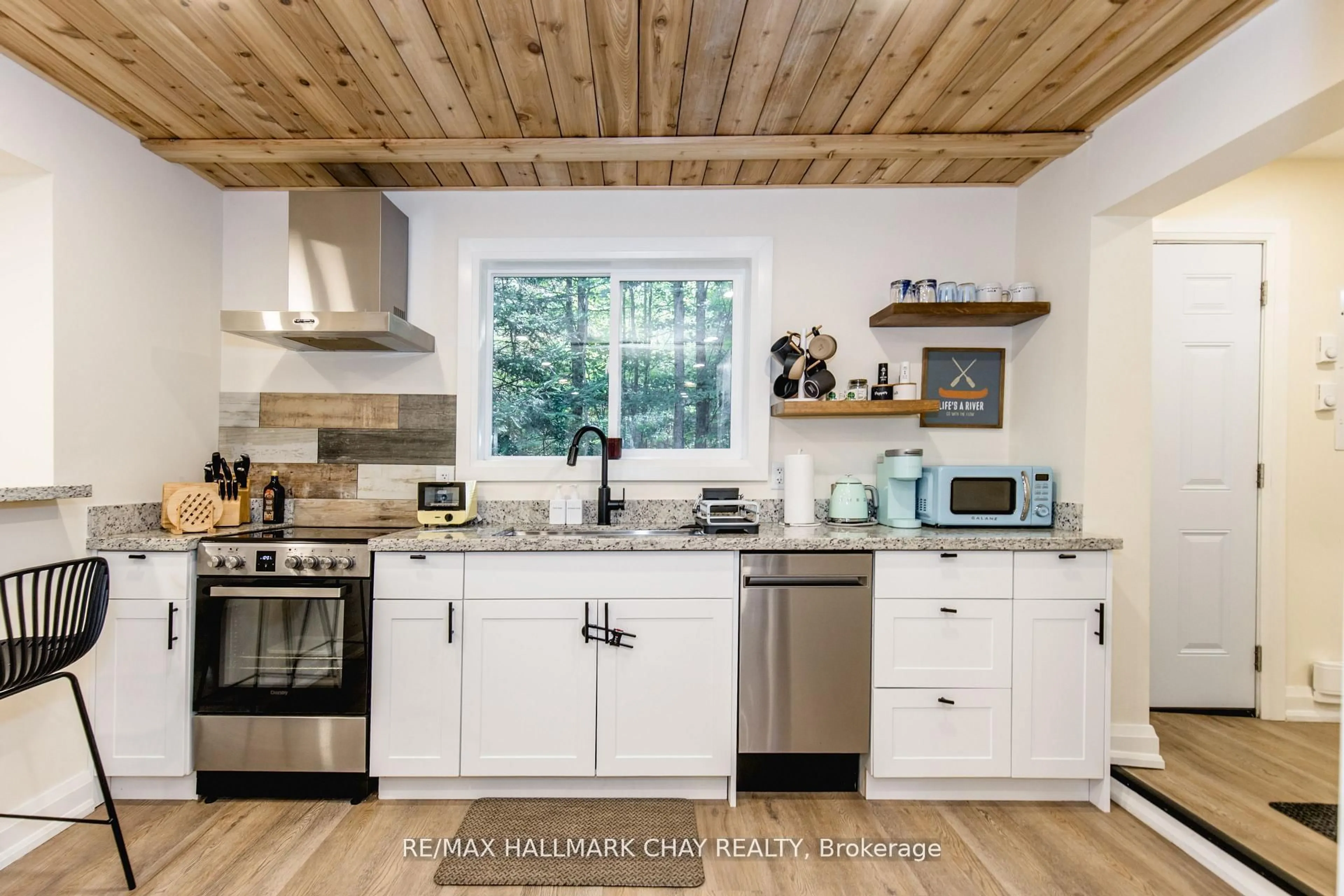 Open concept kitchen, wood/laminate floor for 182 Brodie Kay Tr, Huntsville Ontario P0B 1L0