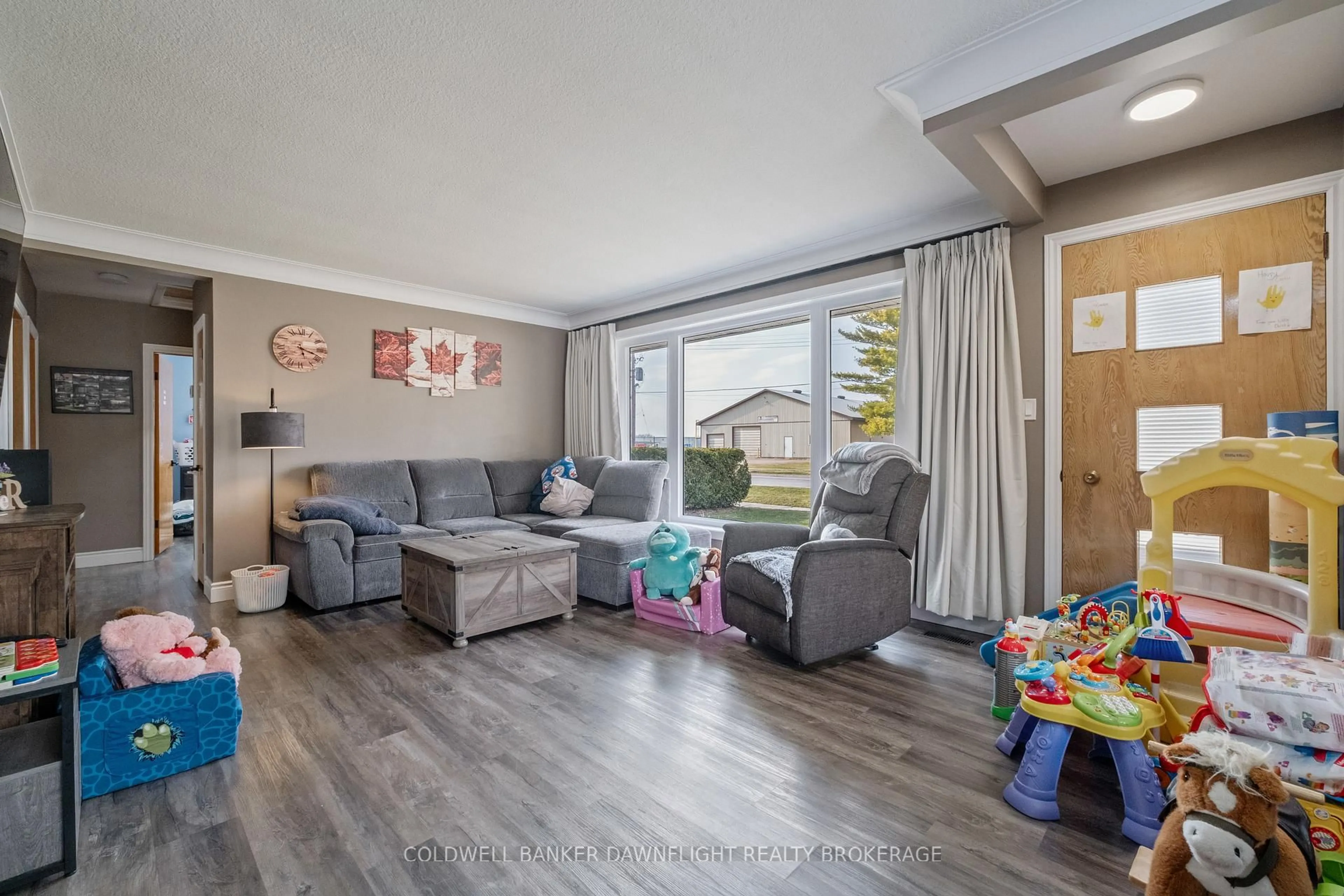 Living room with furniture, wood/laminate floor for 105 Wellington St, South Huron Ontario N0M 1S2