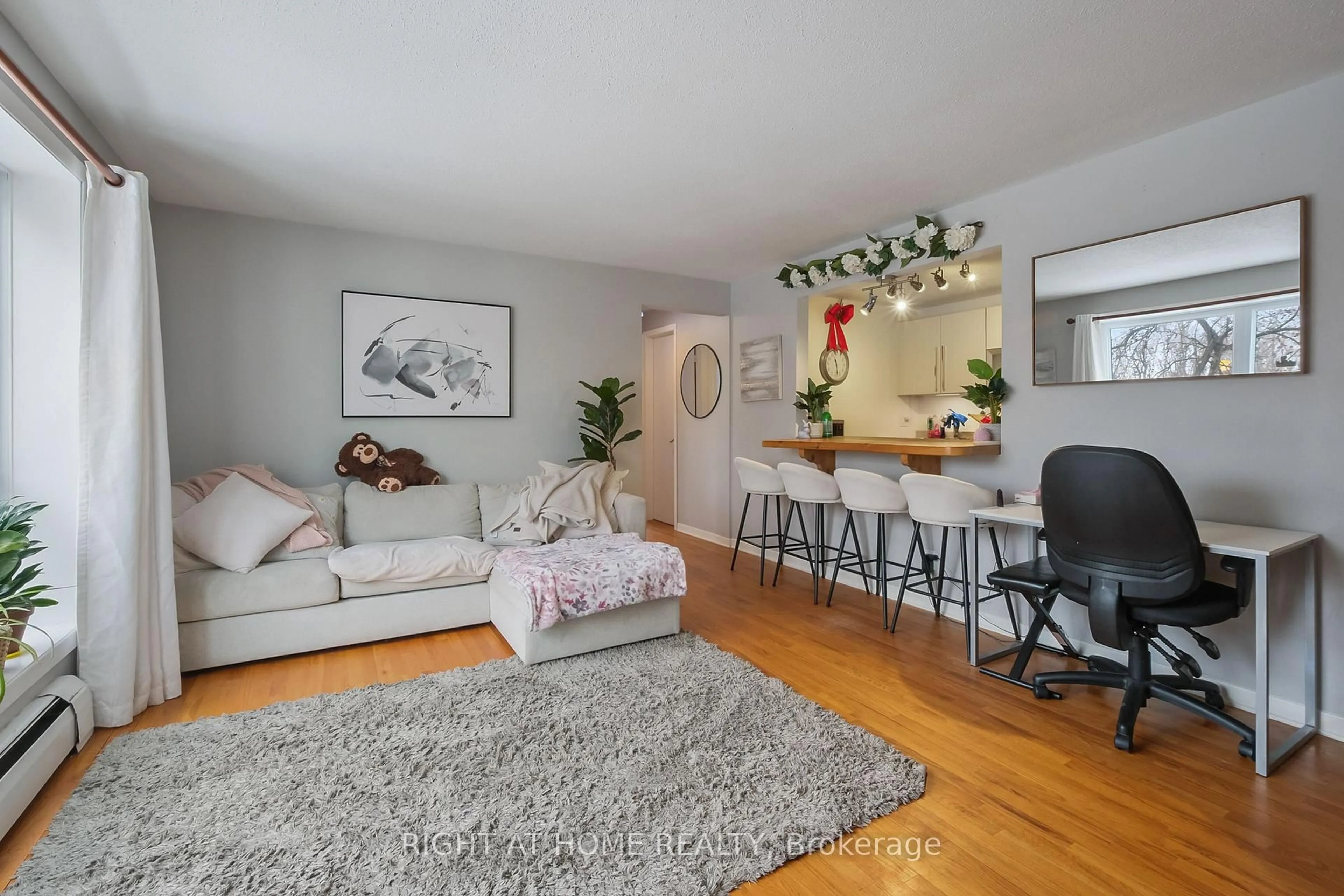 Living room with furniture, wood/laminate floor for 898 Elmsmere Rd #11, Ottawa Ontario K1J 7T6